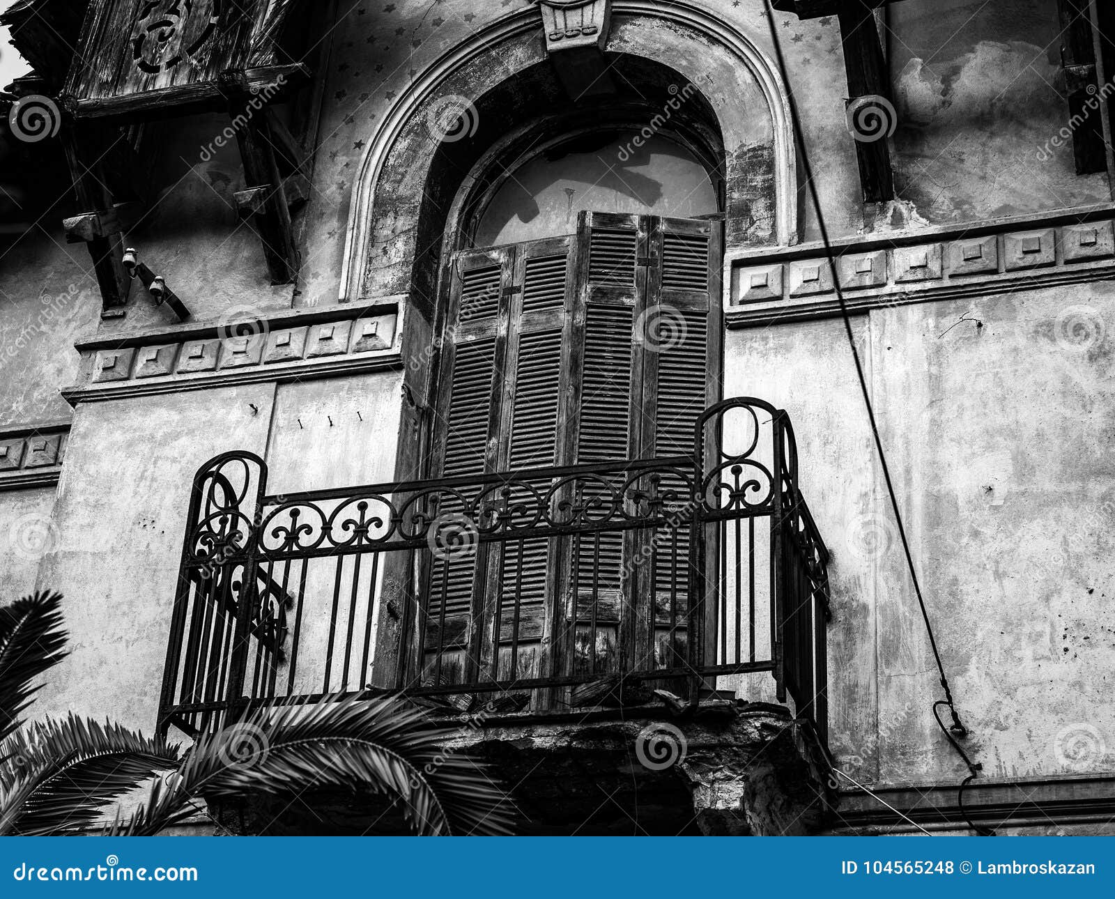 architeture details of abandoned hundred years old house, balconies in black and white