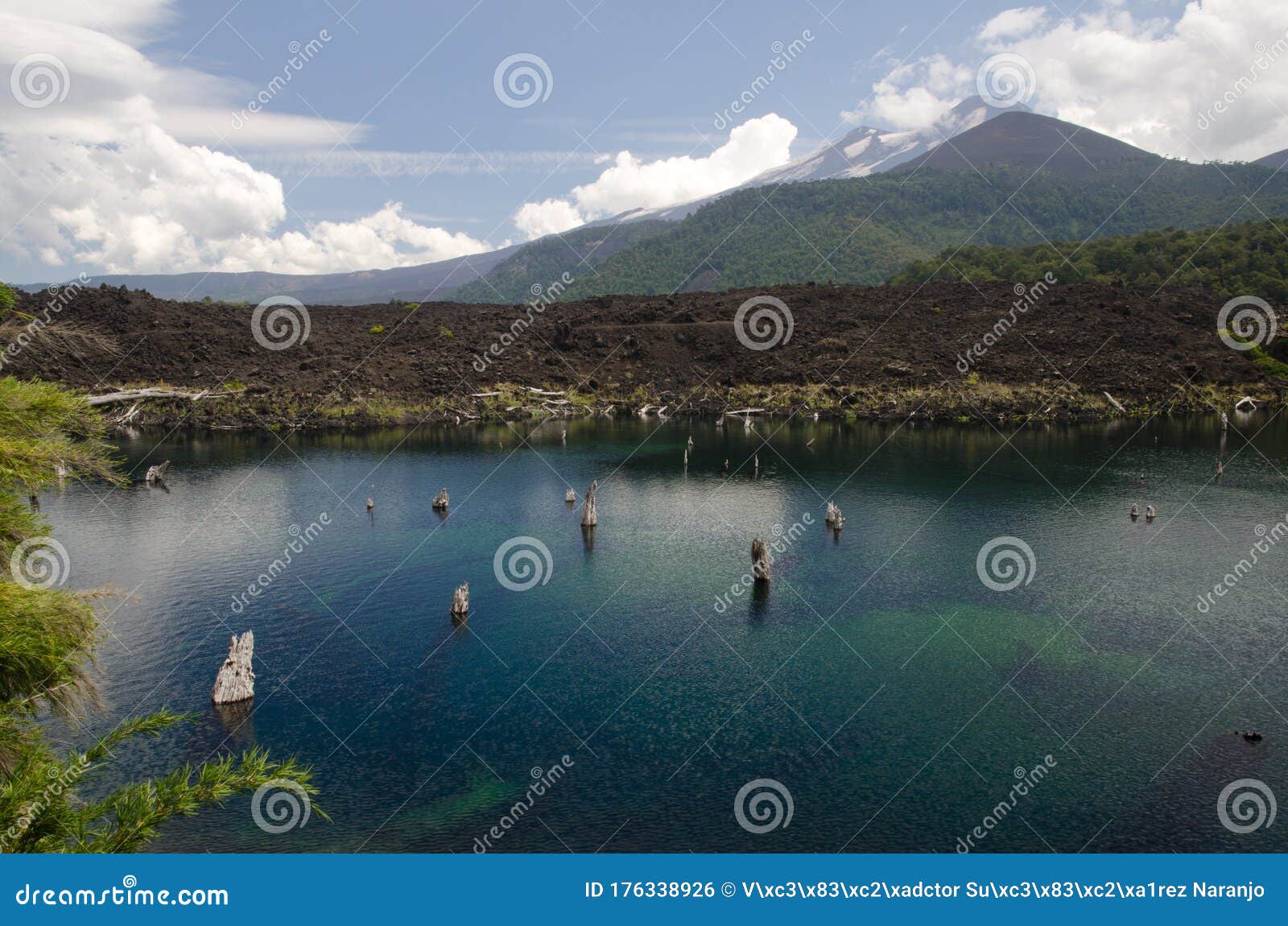 arco iris lagoon and llaima volcano covered by clouds.