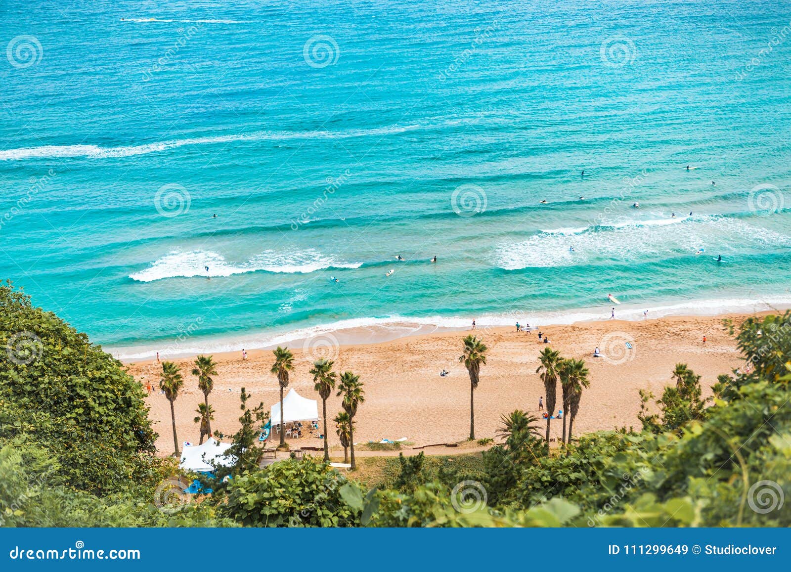 areal shot of beautiful jeju island beach with lots of enthusiastic surfers swimming i