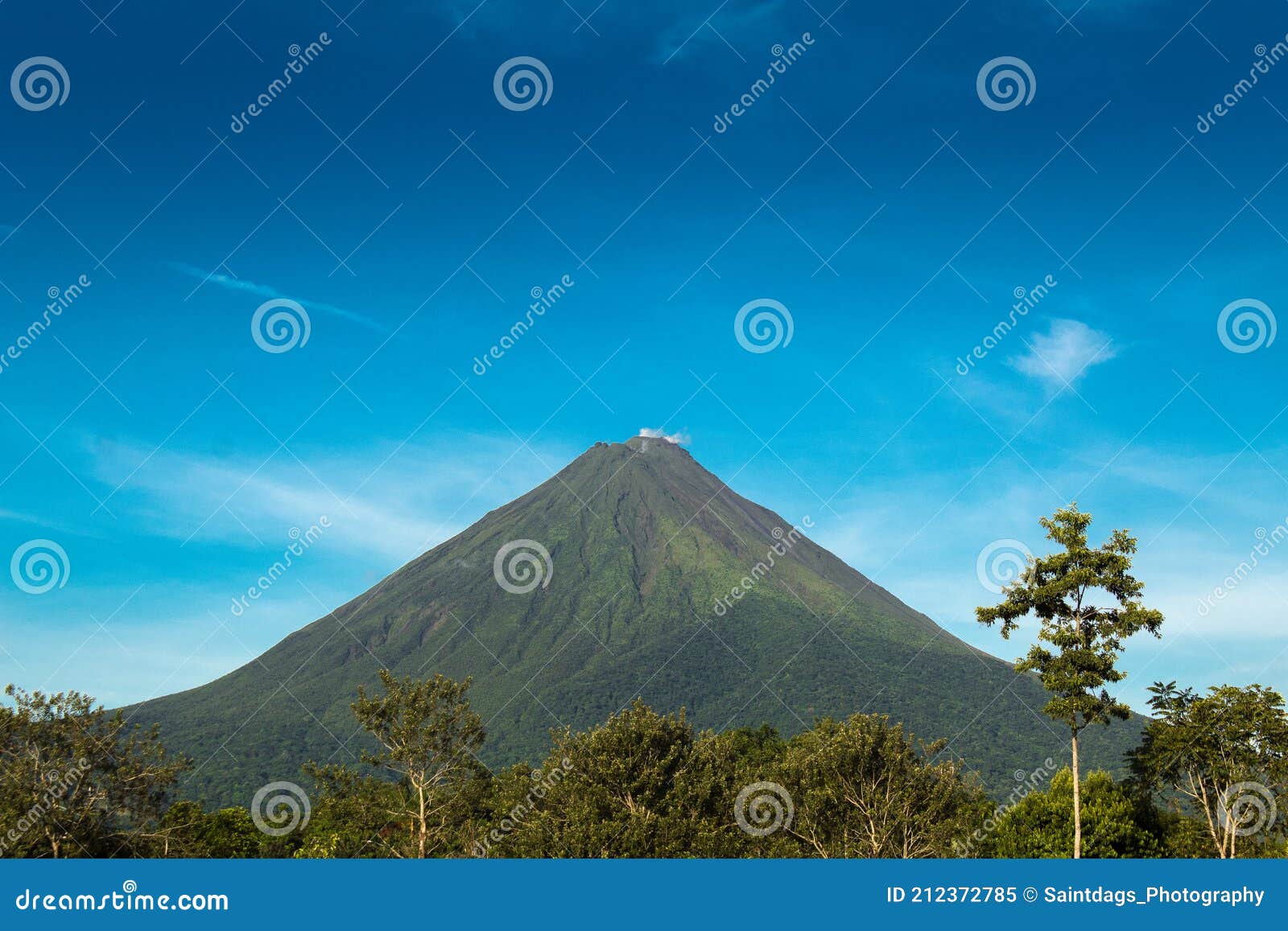 arenal volcano view in a sunny day with blue sky and green nature