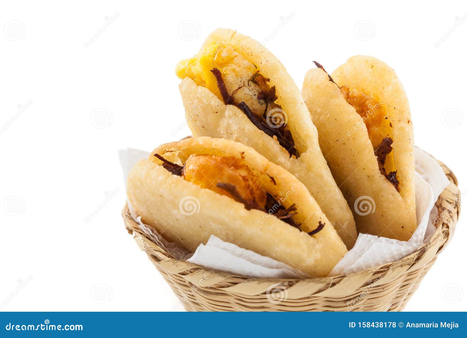 arepa de huevo. traditional colombian fried arepa filled with egg and shredded meat on white background
