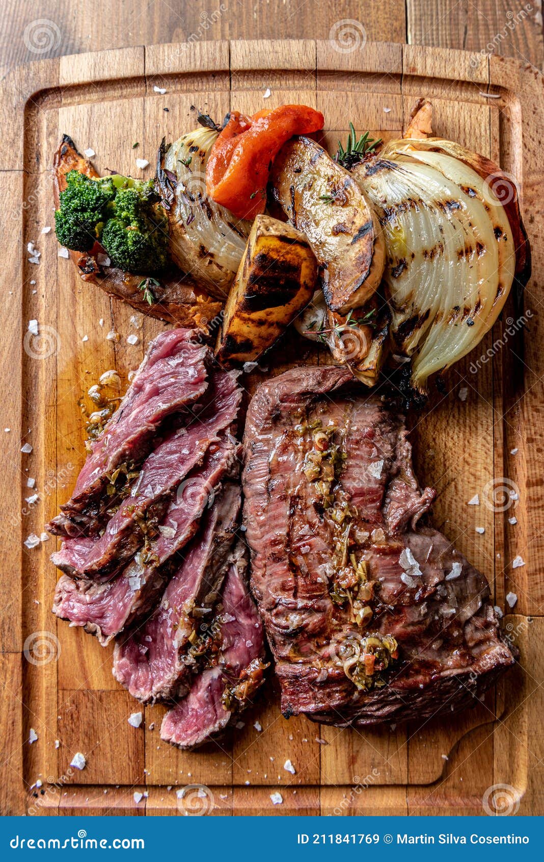 argentine cut of meat called vacio with chorizos and chimichurri