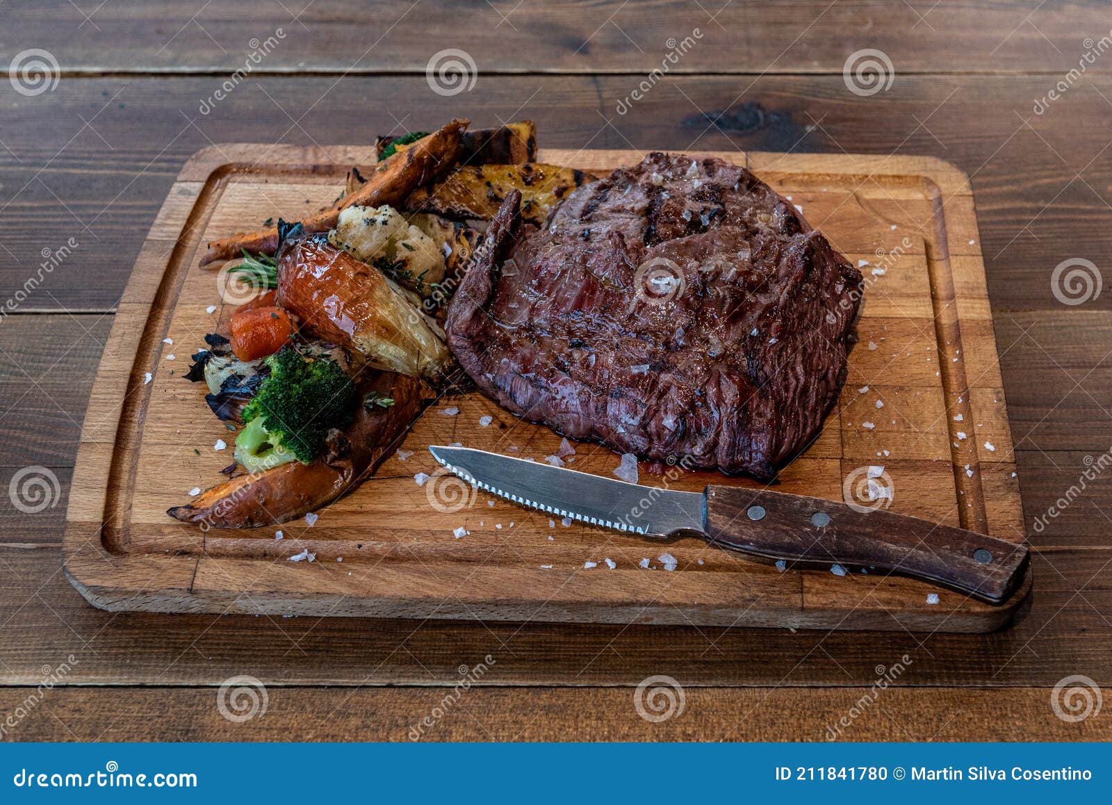 argentine cut of meat called vacio with chorizos and chimichurri