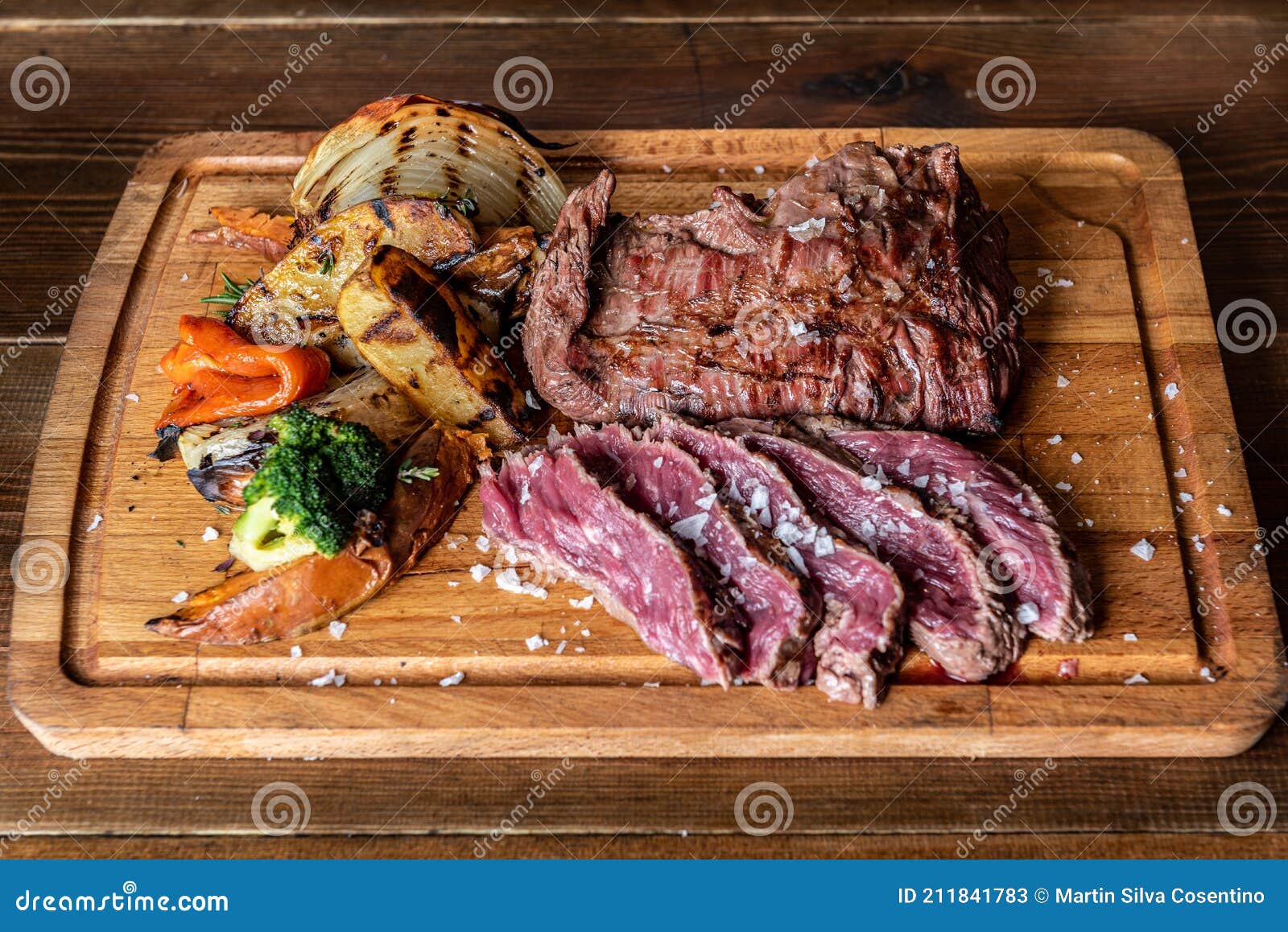 argentine cut of meat called vacio with chorizos and chimichurri