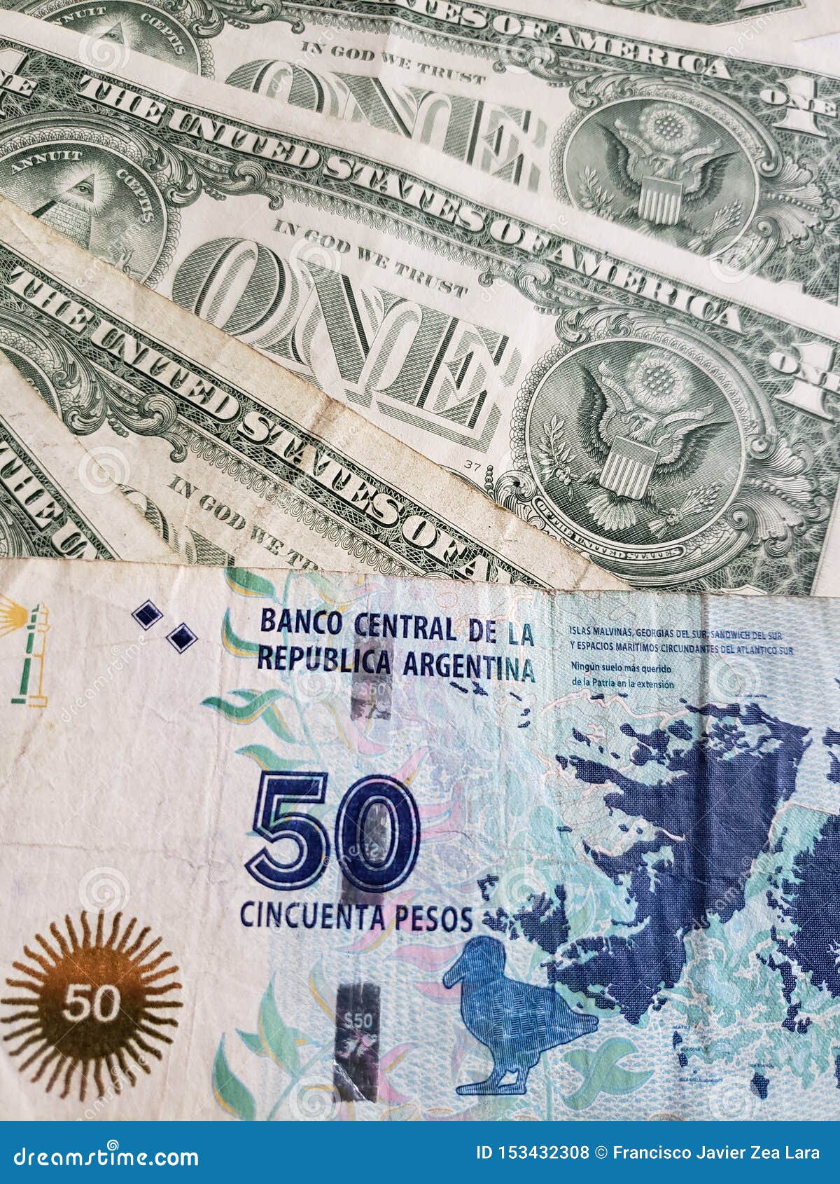 argentinean banknote of fifty pesos and american one dollar bills
