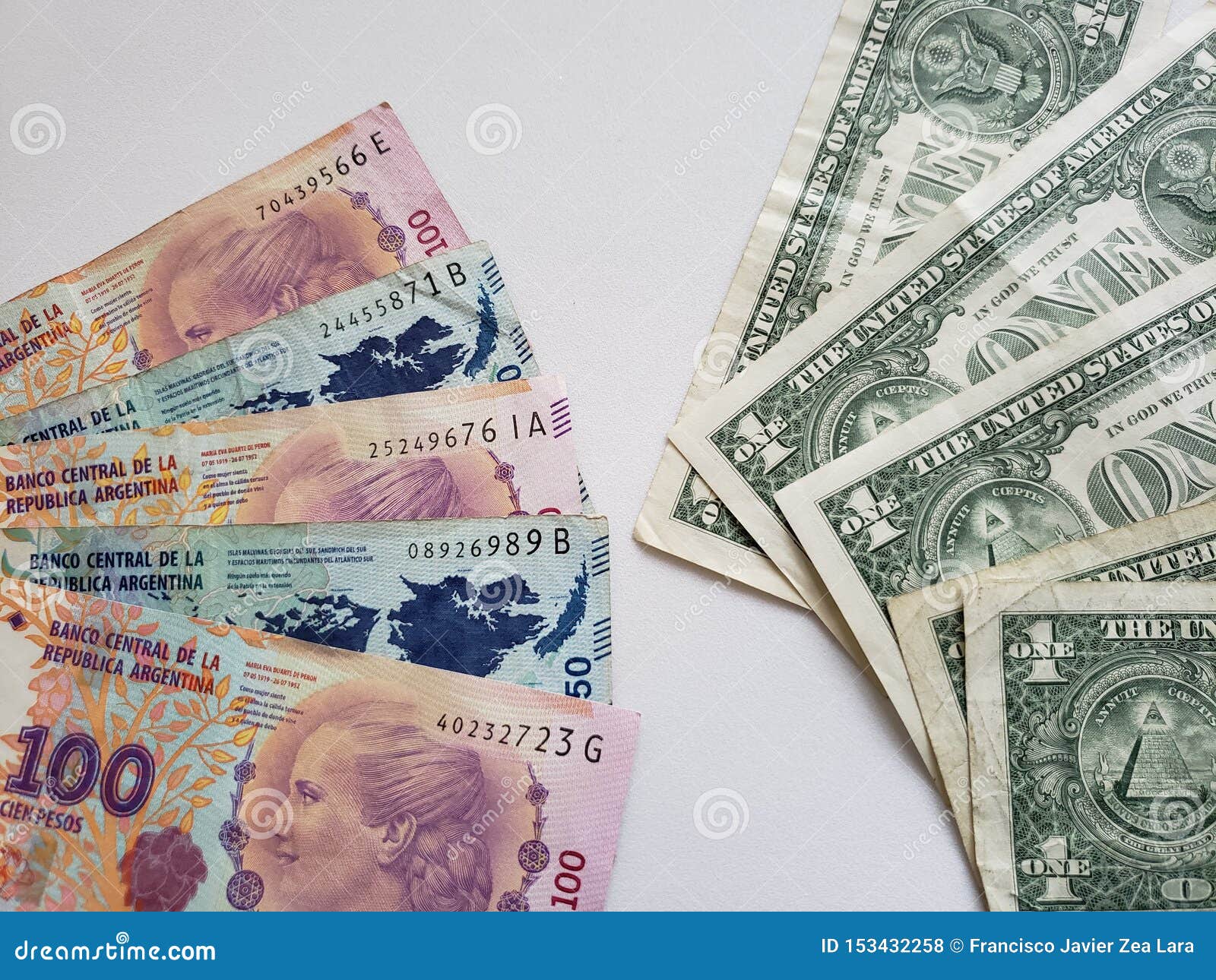 argentinean banknotes and american one dollar bills
