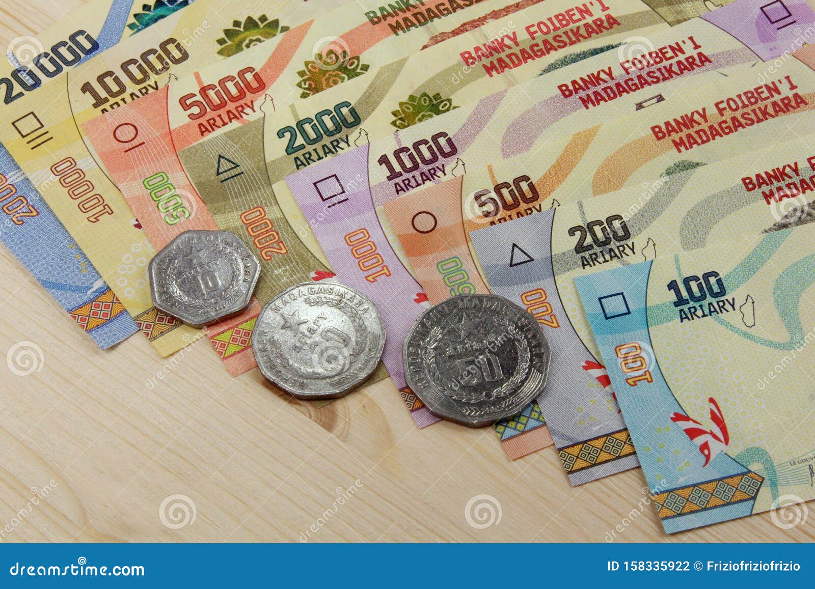 Ariary Banknotes And Coins Of The State Of Madagascar Stock Photo ariary-banknotes-and-coins-of-the-state-of-madagascar-stock-photo