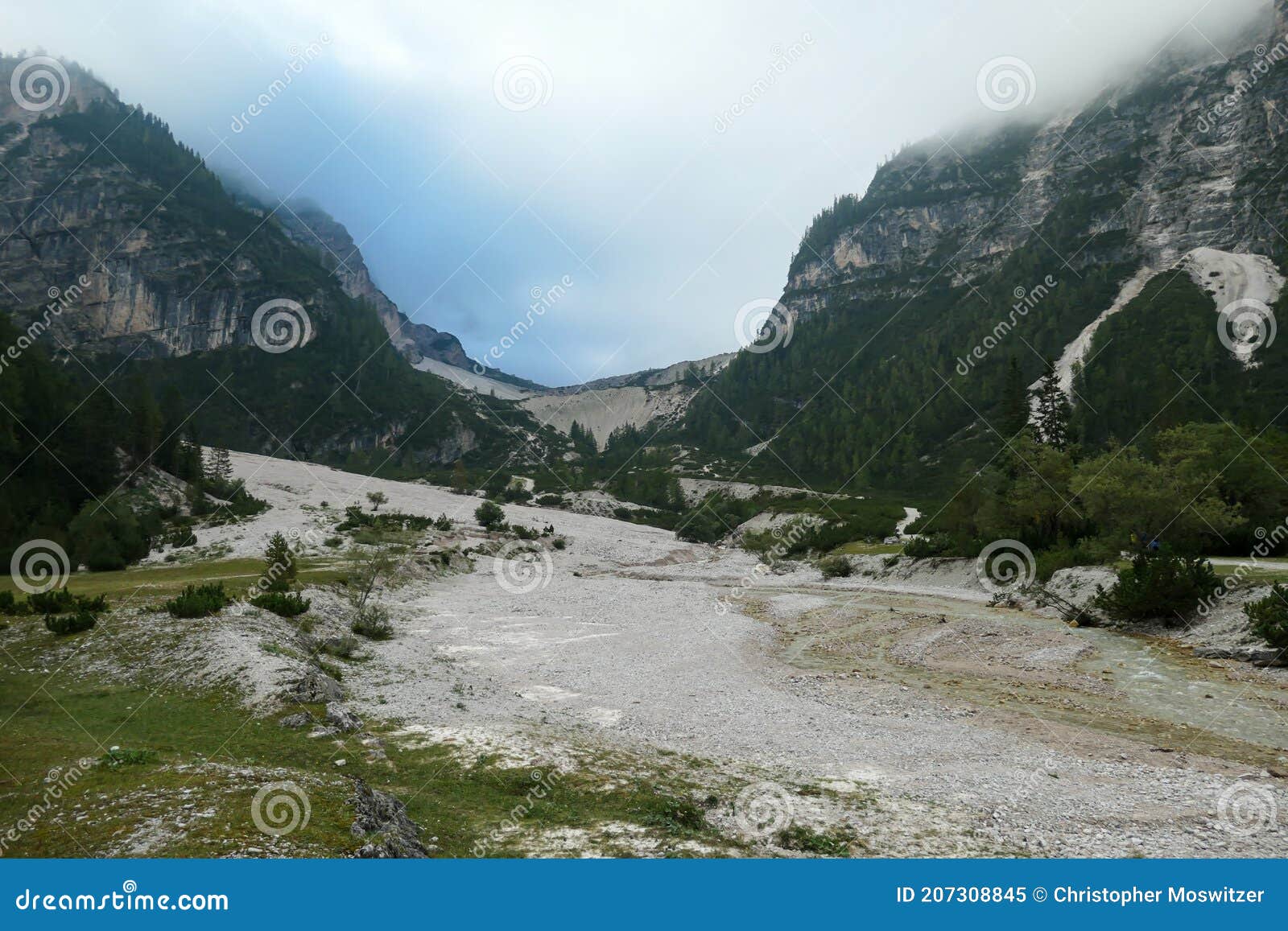 armentarola - a panoramic view on a vast valley in italian dolomites. the bottom of the valley is very wide, covered with pebbles