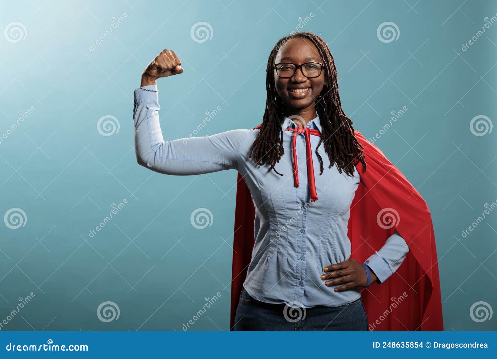 arms muscle flexing brave superhero woman posing strong and tough for camera on blue background.