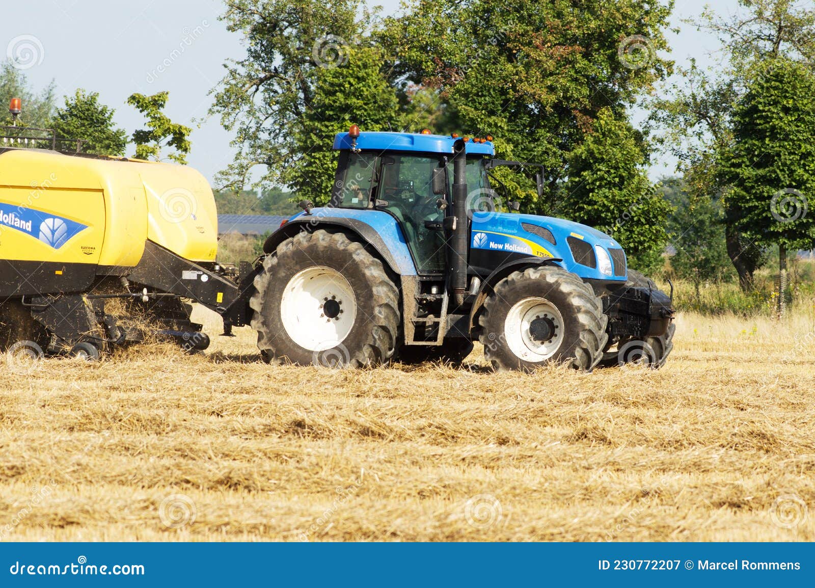 Blue Tractor Of City Service Riding On A Street. Tracktor MTZ82