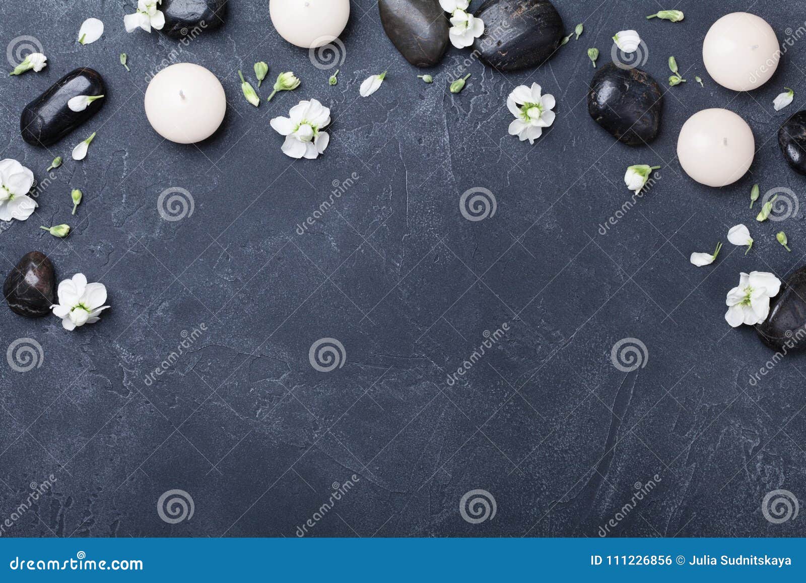 aromatherapy and spa composition decorated flowers on black stone background top view. beauty treatment and relaxation concept.
