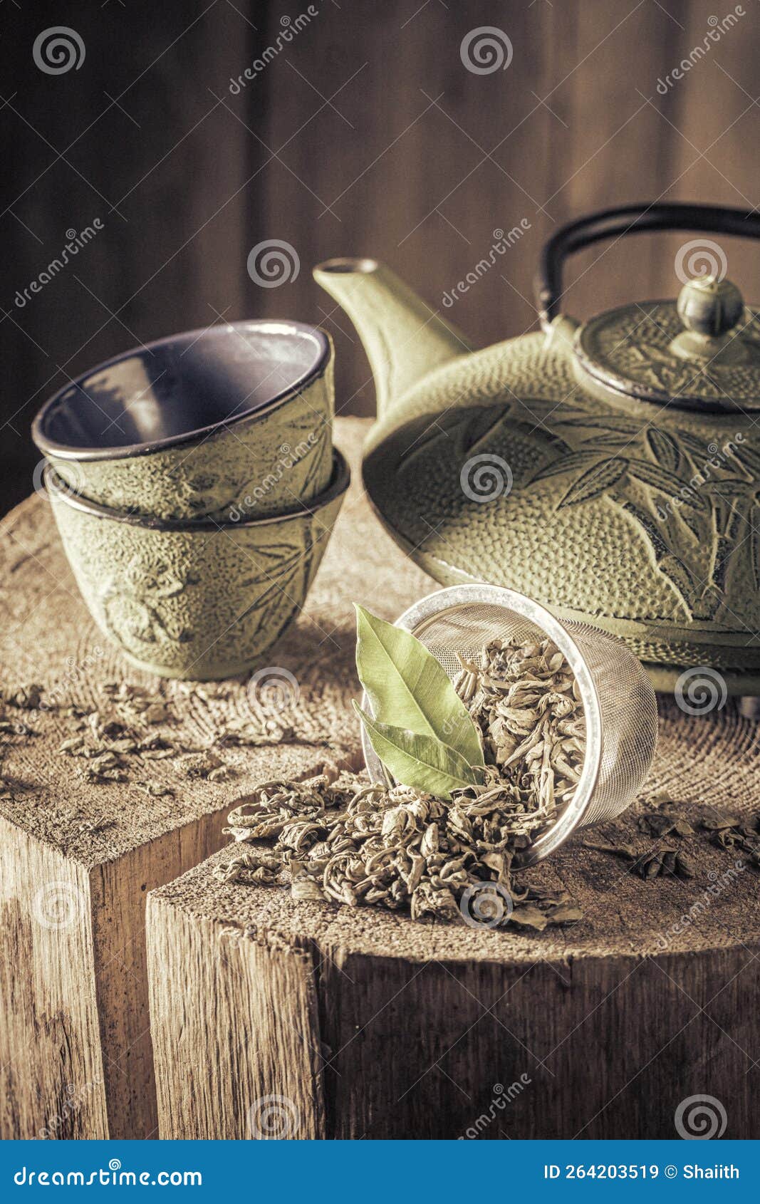 Aromatic and Leafy Green Tea with Iron Teapot and Cup Stock Image
