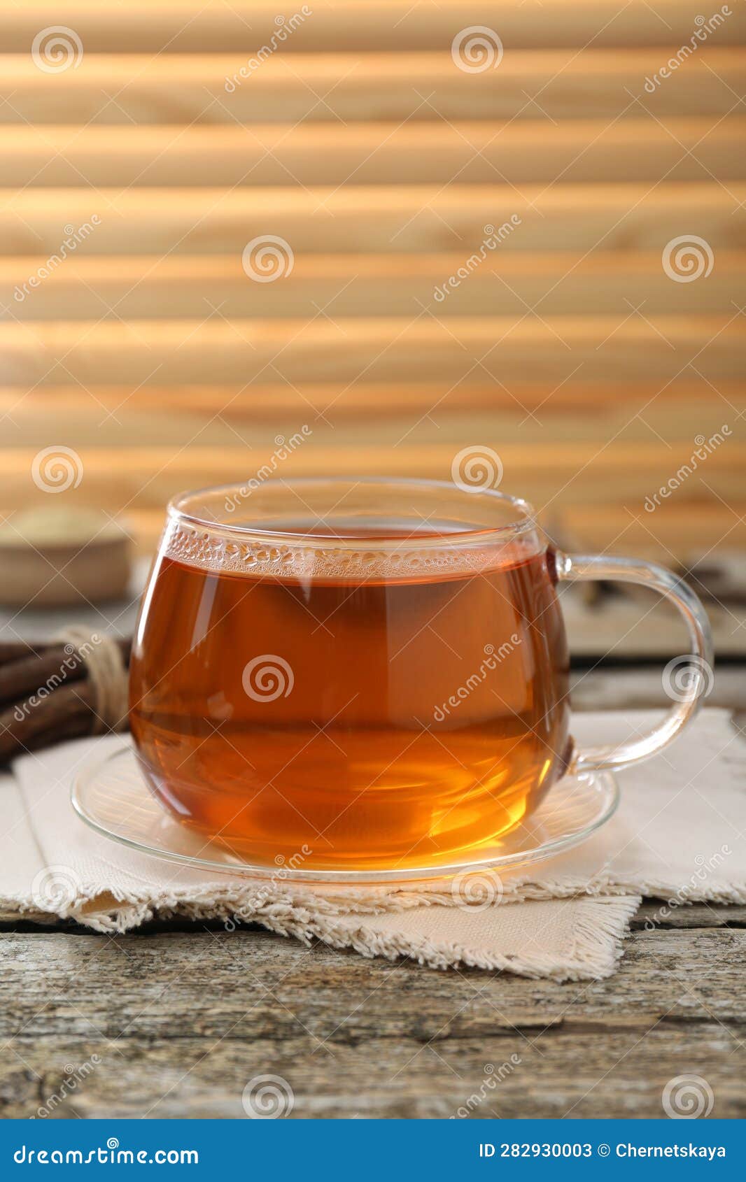 Aromatic Licorice Tea in Cup and Dried Sticks of Licorice Root on