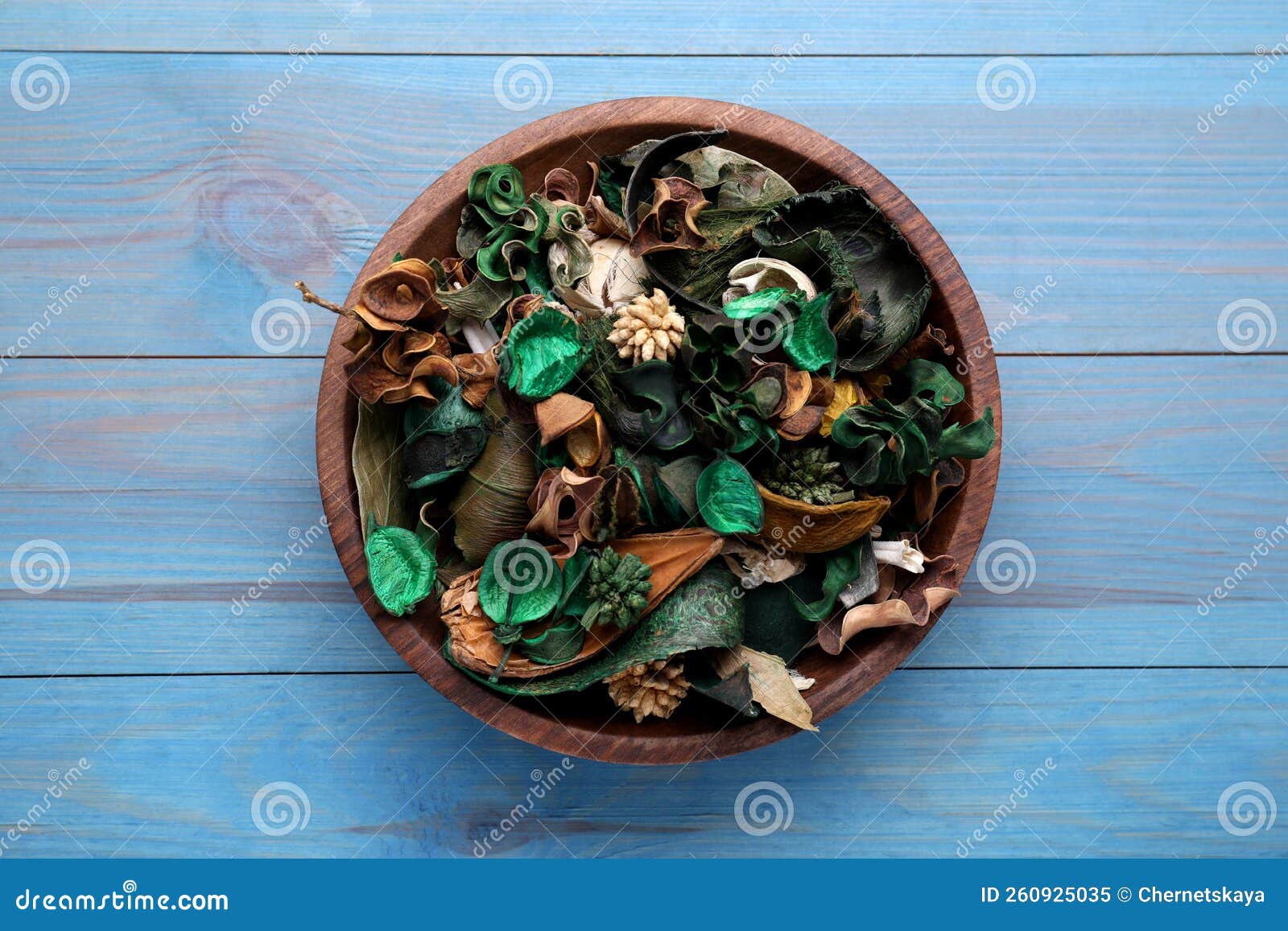 Aromatic Potpourri of Dried Flowers in Bowl on Light Blue Wooden Table