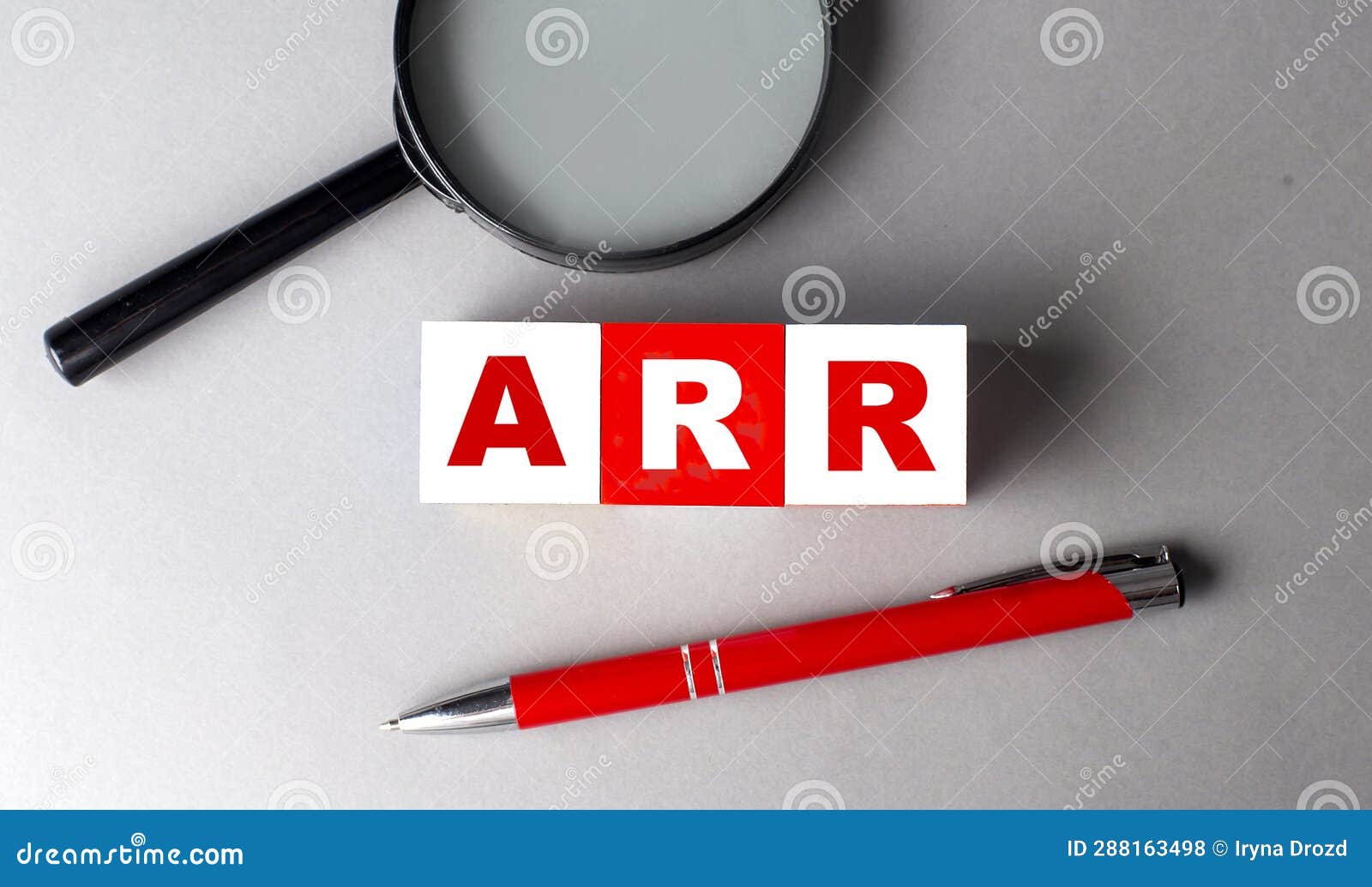 arr word on wooden cubes with pen and magnifier