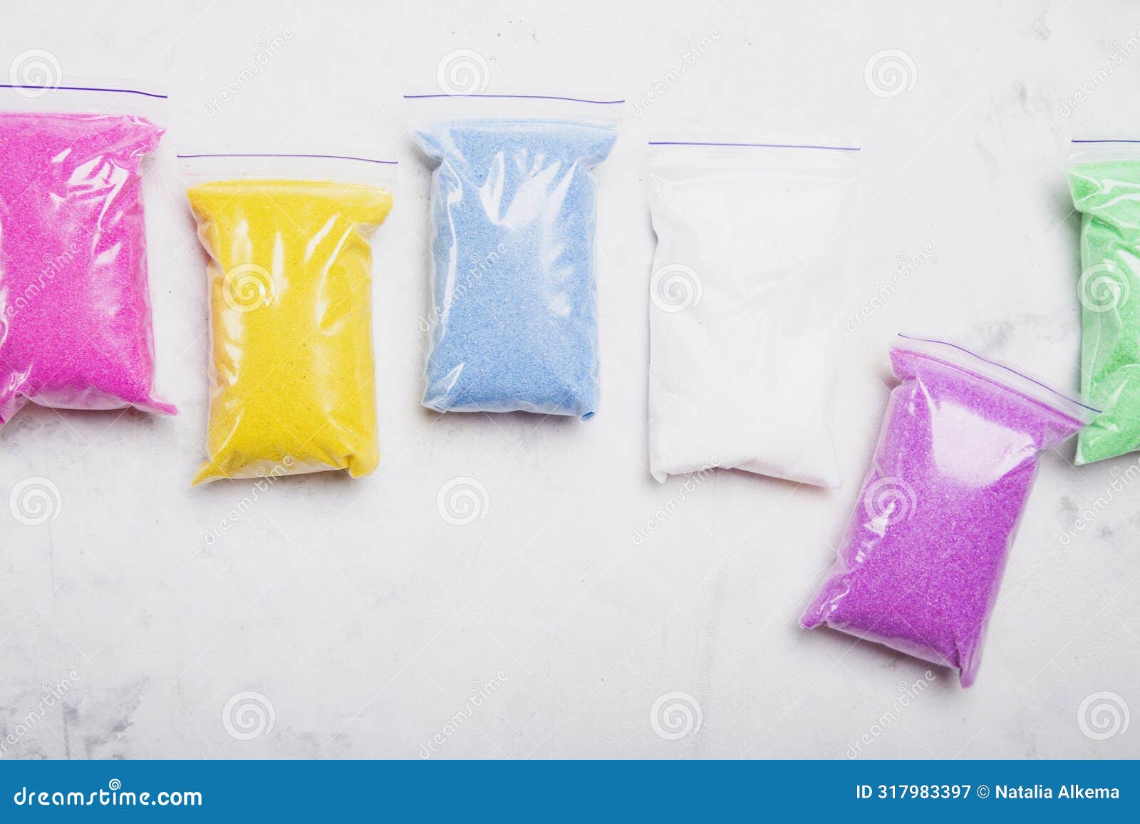 array of bright colored craft sand in sealable bags for creative projects.