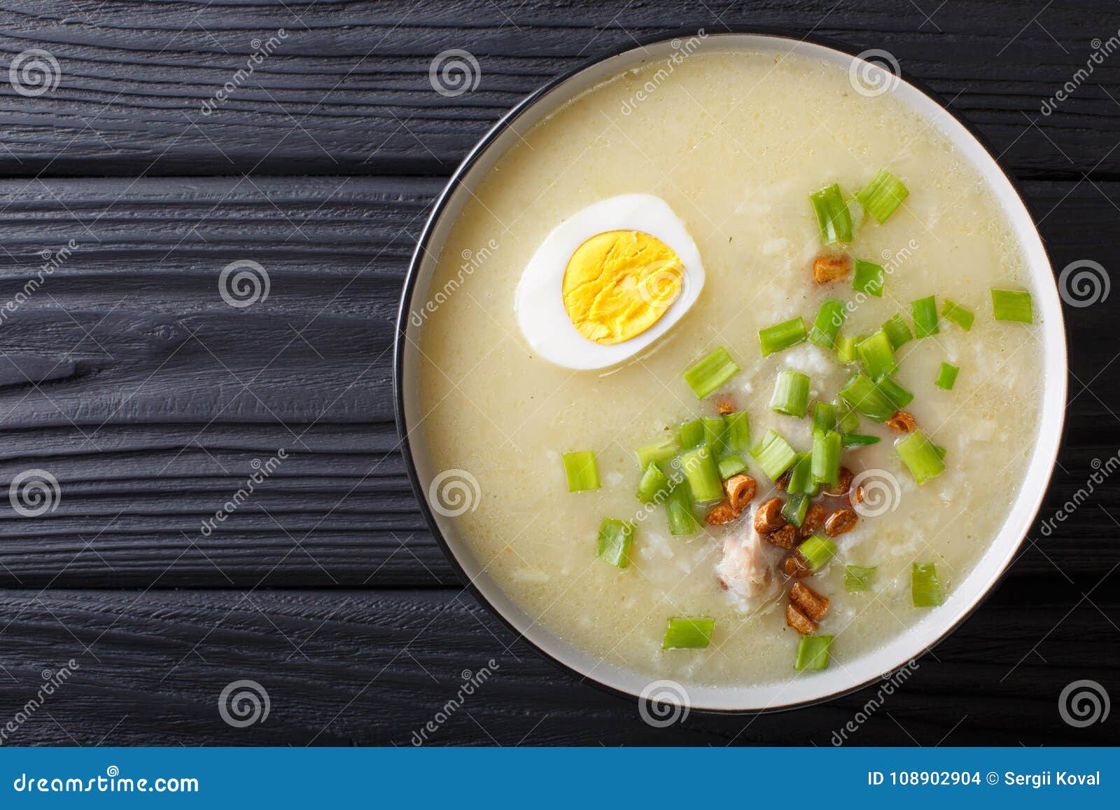 arroz caldo soup with rice, chicken and egg close-up. horizontal