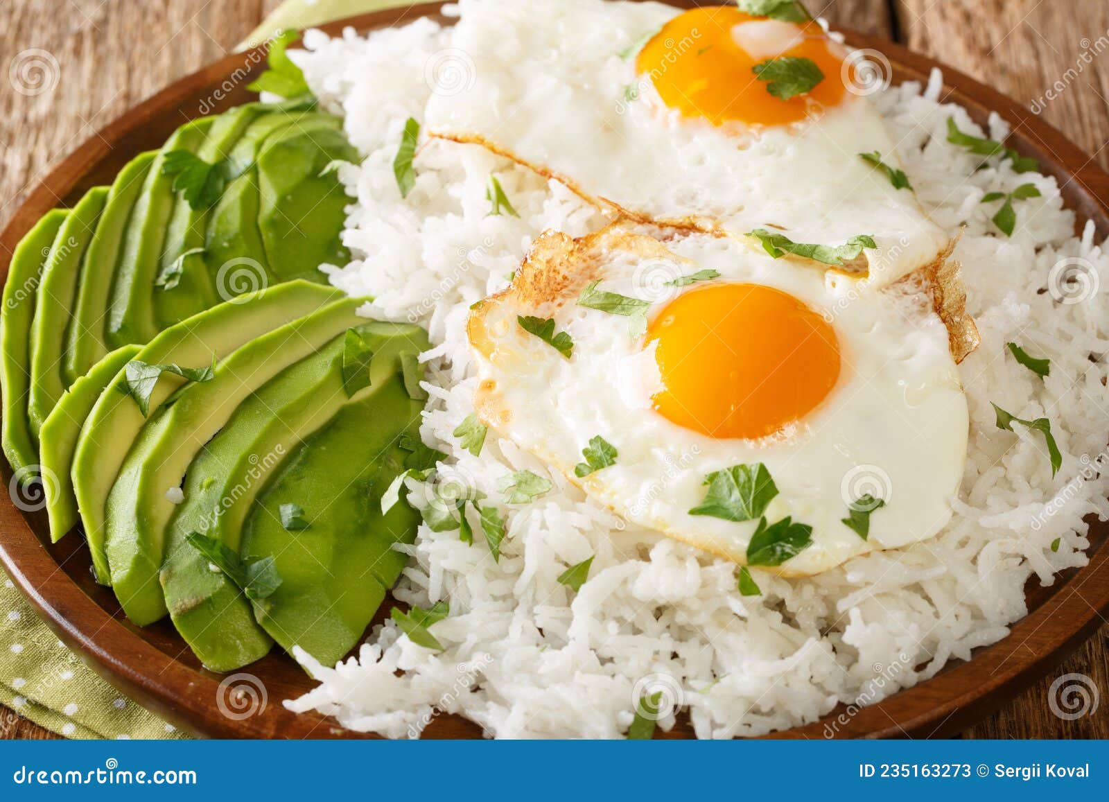 arroz con huevo frito is white rice and a fried egg close up in the plate. horizontal