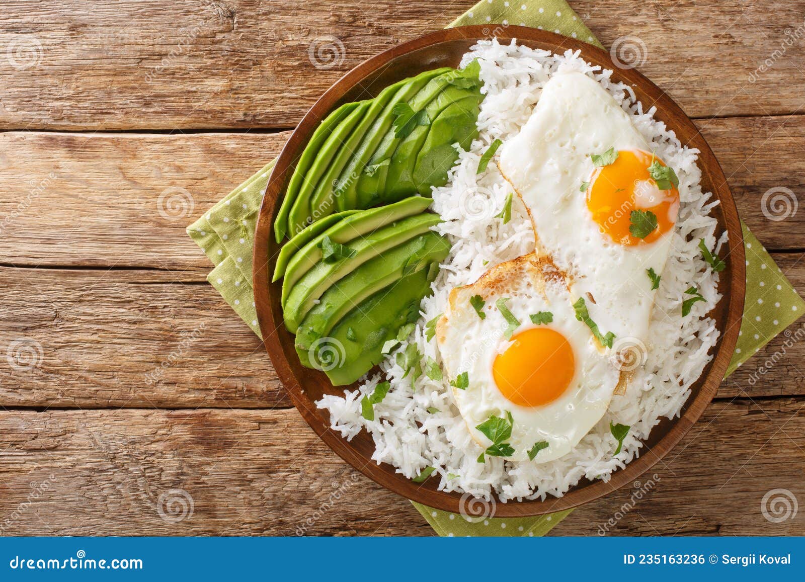 arroz con huevo frito is white rice and a fried egg close up in the plate. horizontal top view