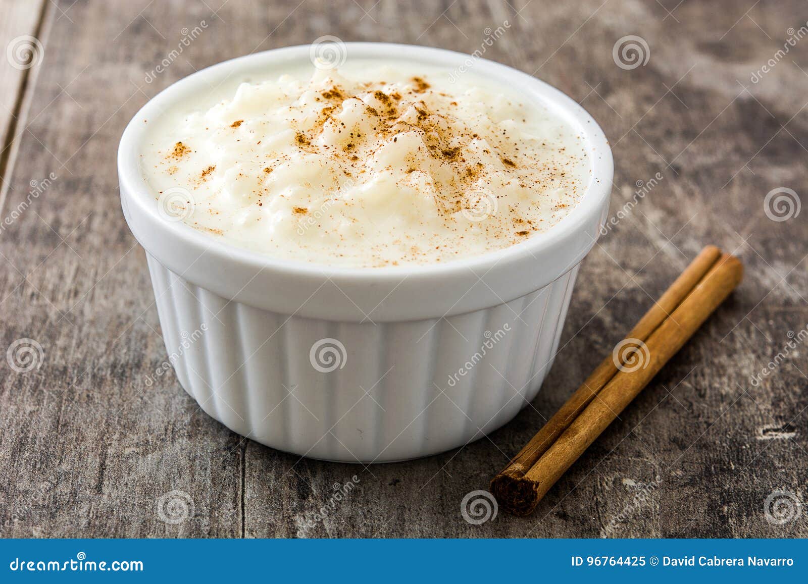 arroz con leche. rice pudding with cinnamon on wood