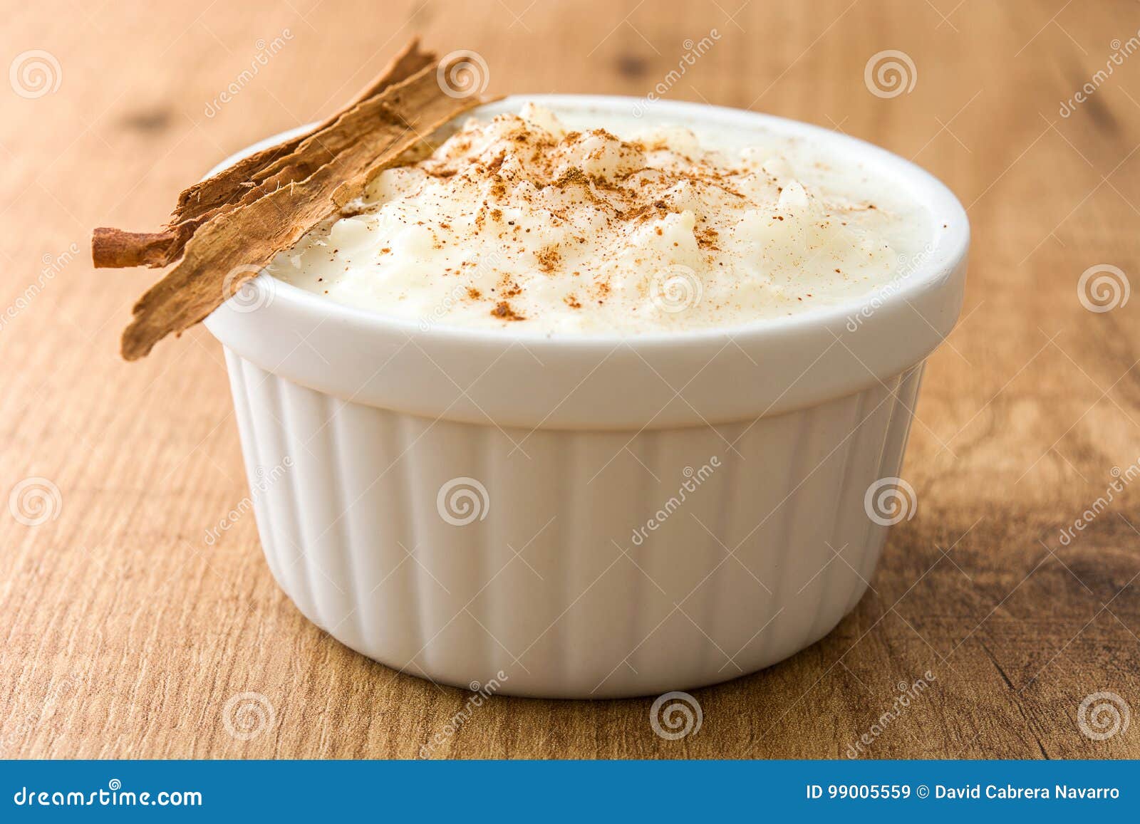 arroz con leche. rice pudding with cinnamon on wood