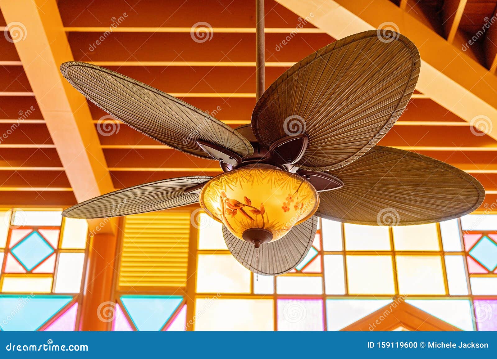 An Art Deco Fan Against Brightly Lit Lead Light Windows Stock Photo Image Of Exotic