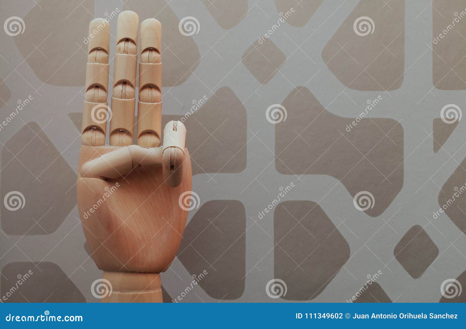 articulated wooden hand with three fingers raised in allusion to number three