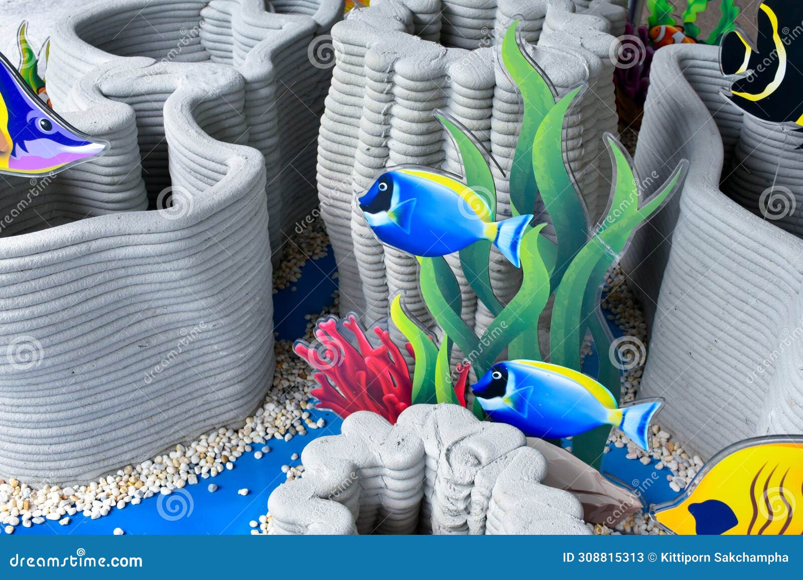 artificial coral reef models and marine fish models are beautifully arranged to be used as props to simulate the ocean or sea