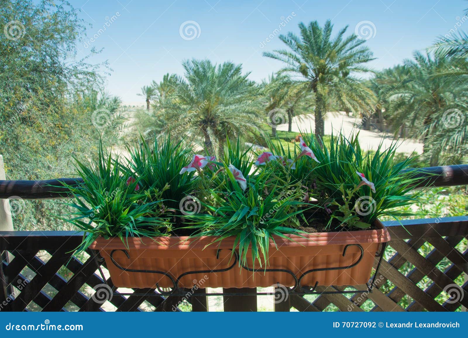 Artificial Flowers Inside Big Brown Plastic Pot on the Balcony with