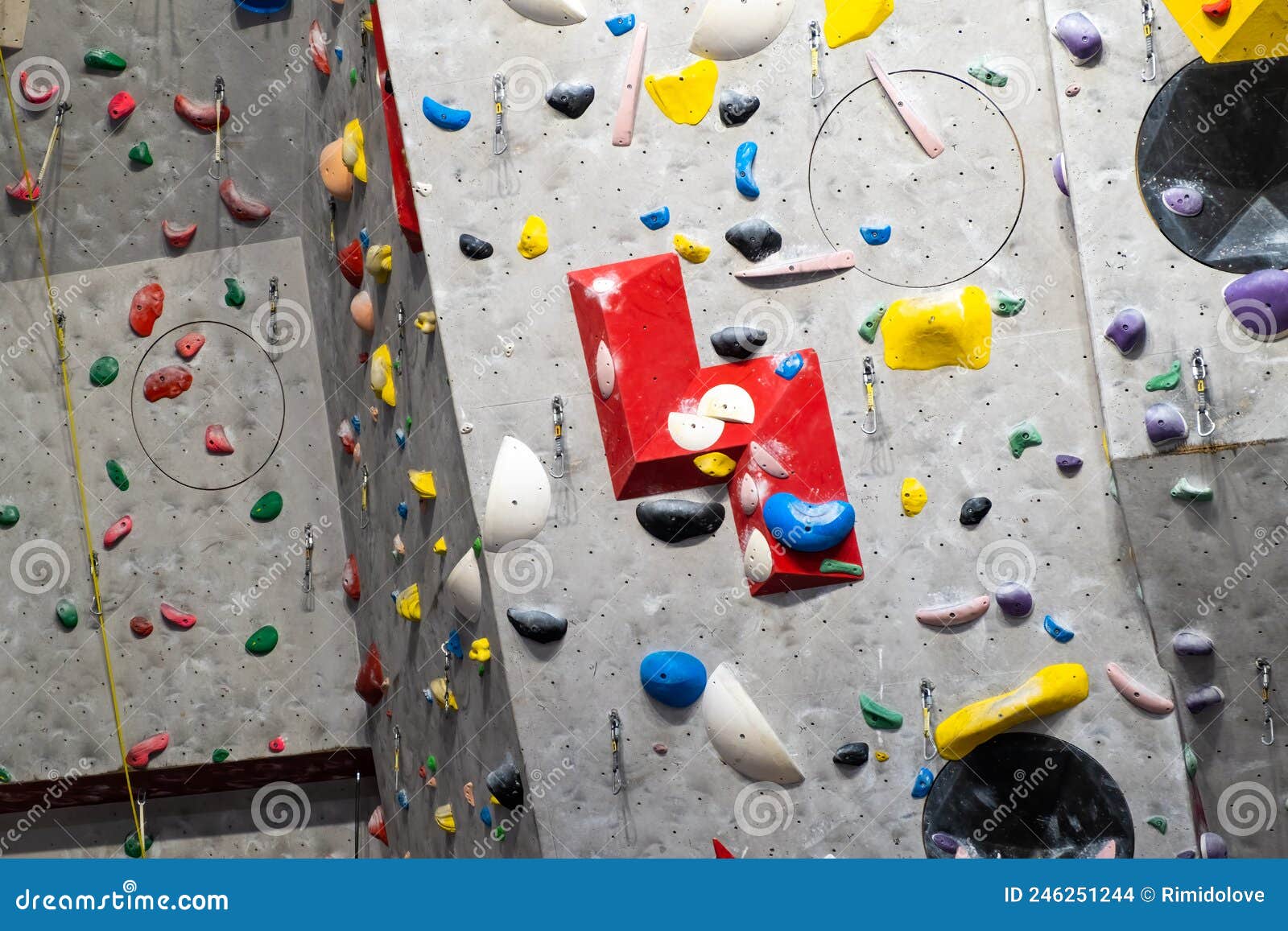 Artificial Rock Climbing Wall with Various Colored Grips Stock Photo