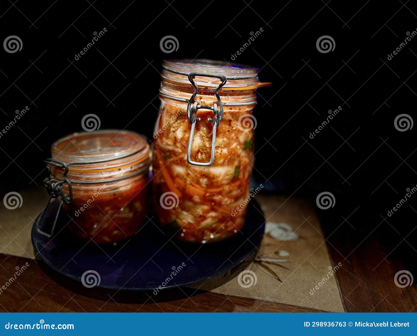 Artisanal Kimchi in ClampTop Jars on Dark Wooden Surface with Dramatic
