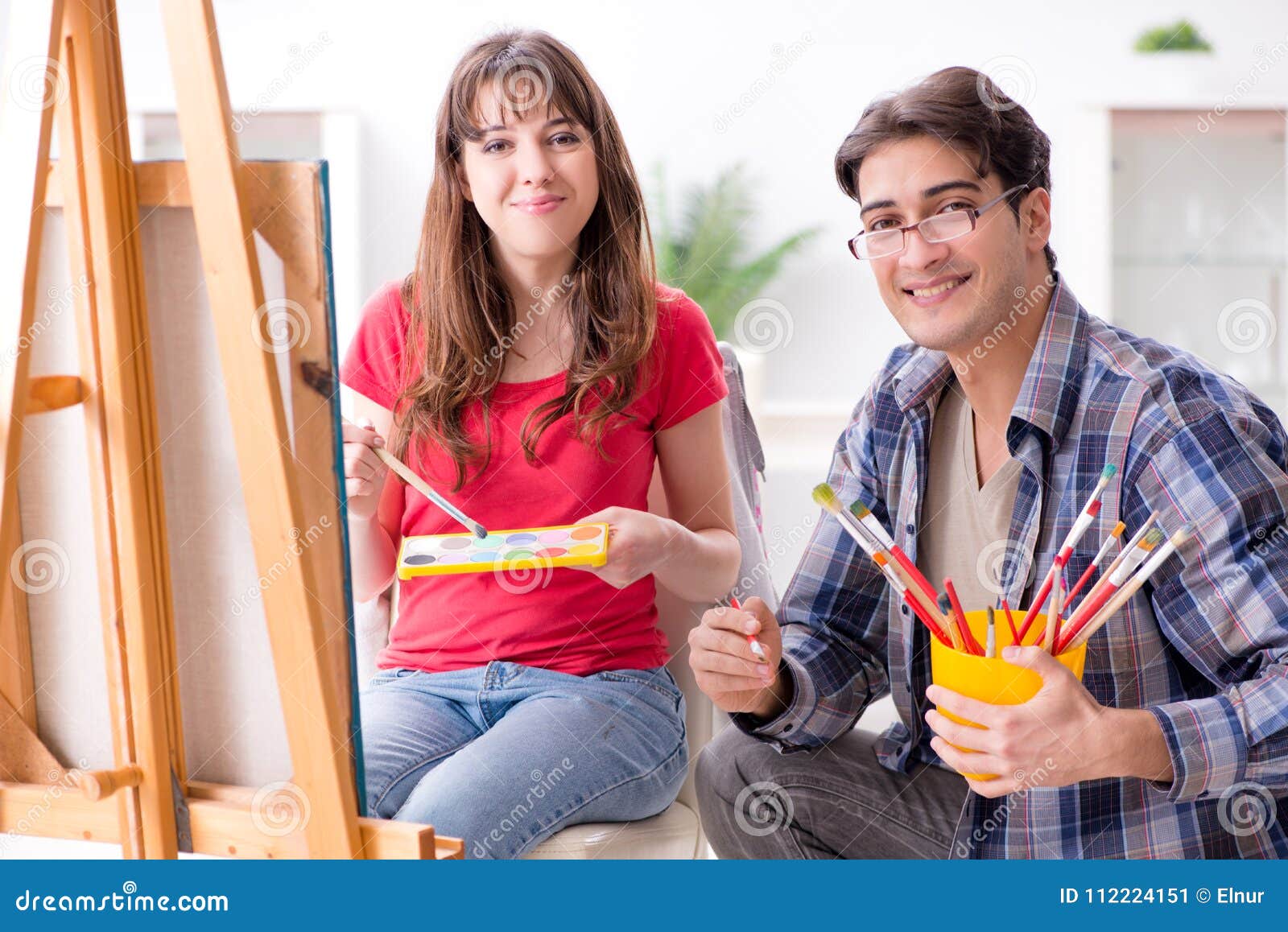 The Artist Coaching Student in Painting Class in Studio Stock Image