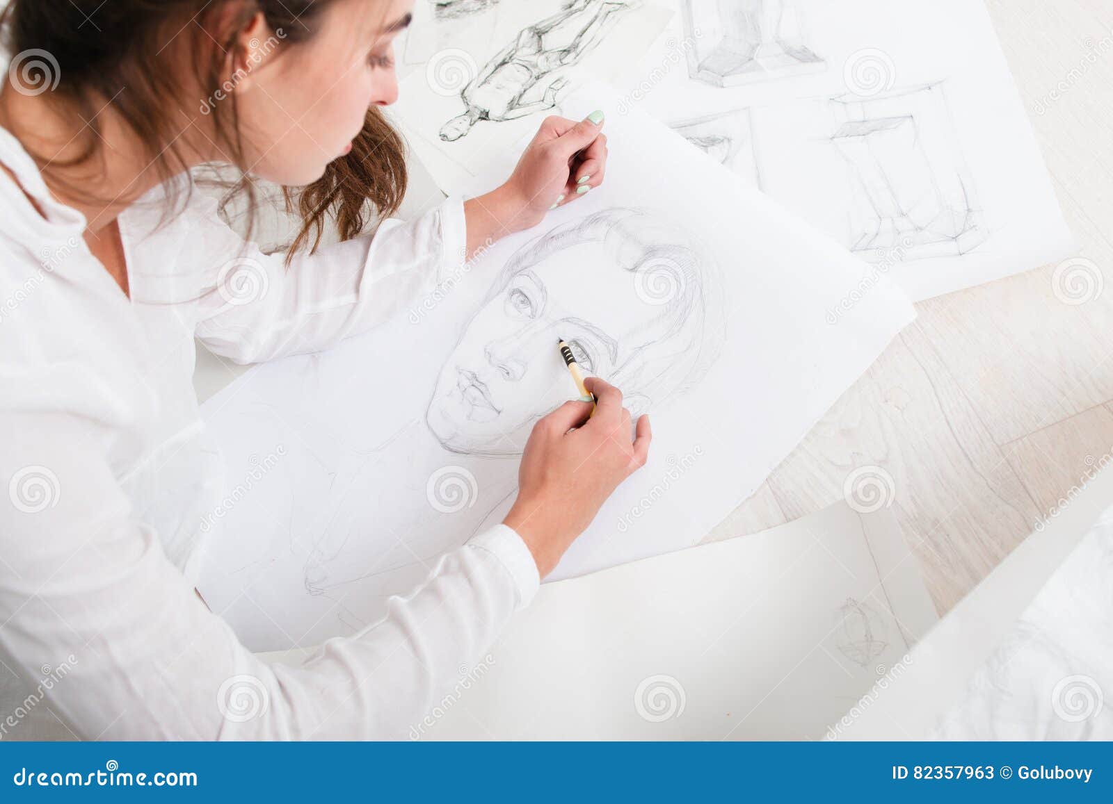 Artist Finishing Human Pencil Portrait On Floor Stock Image