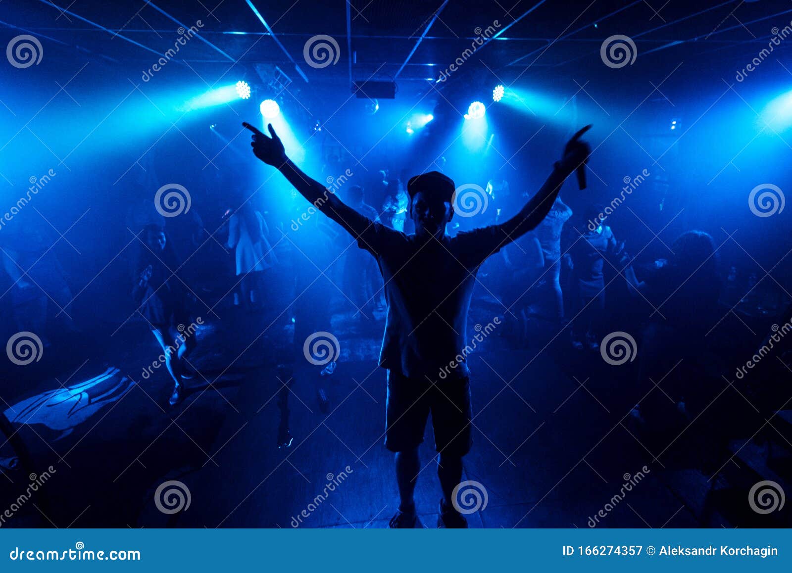 Artist with a Microphone Performs on the Stage of a Stock