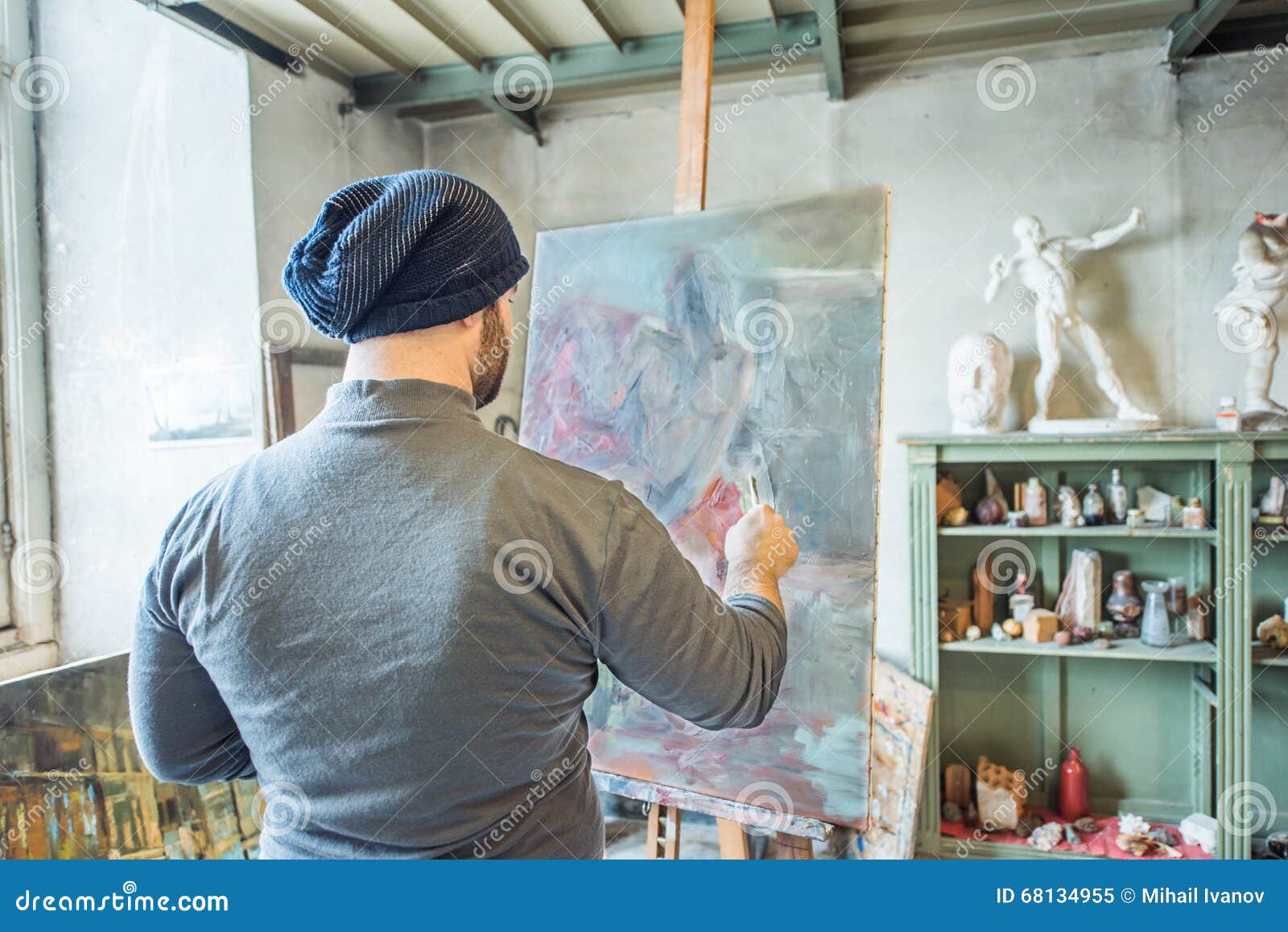 an artist painting a masterpiece at his studio