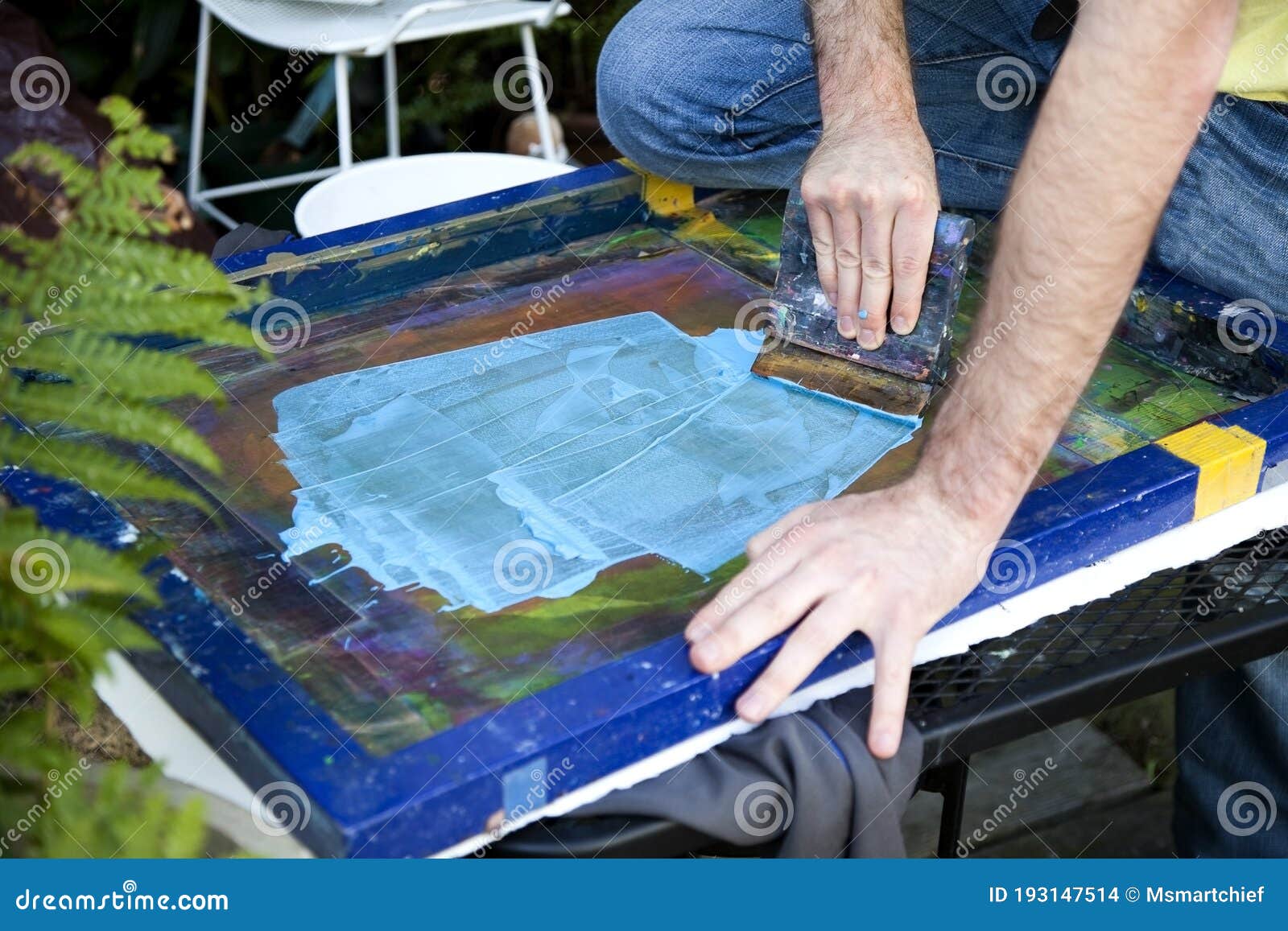 Artist Pulling Squeegee Across Silk Screen. Stock Photo Image of blur