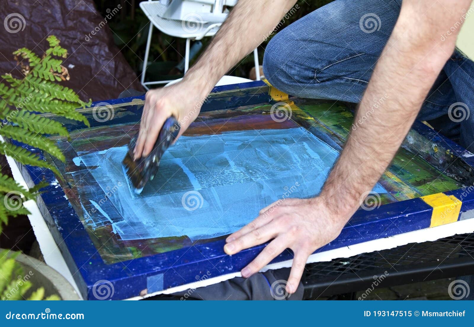 Artist Pulling Squeegee Across Silk Screen. Stock Image Image of