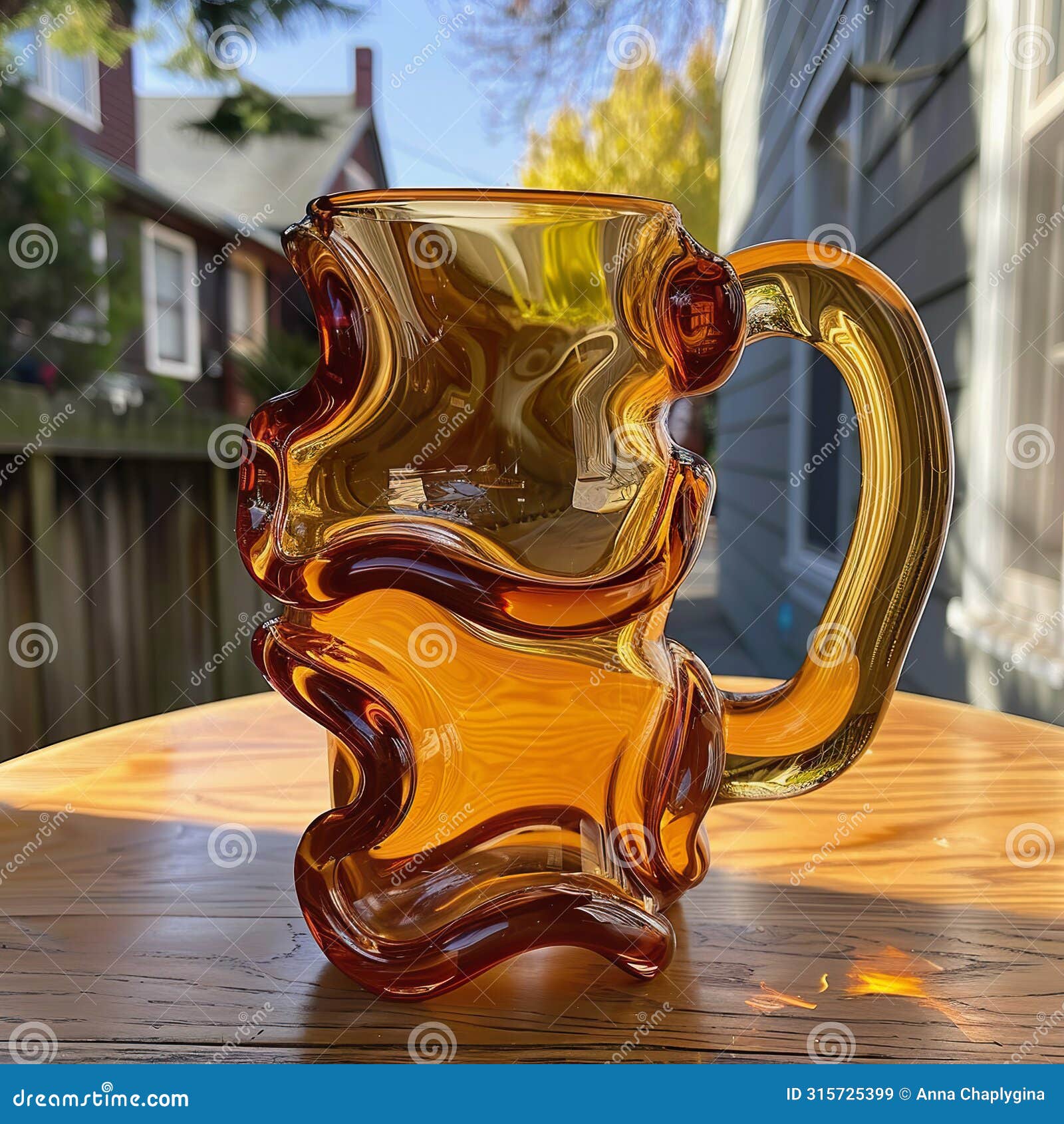 artistic amber glass mug on wooden table, unique squiggly 