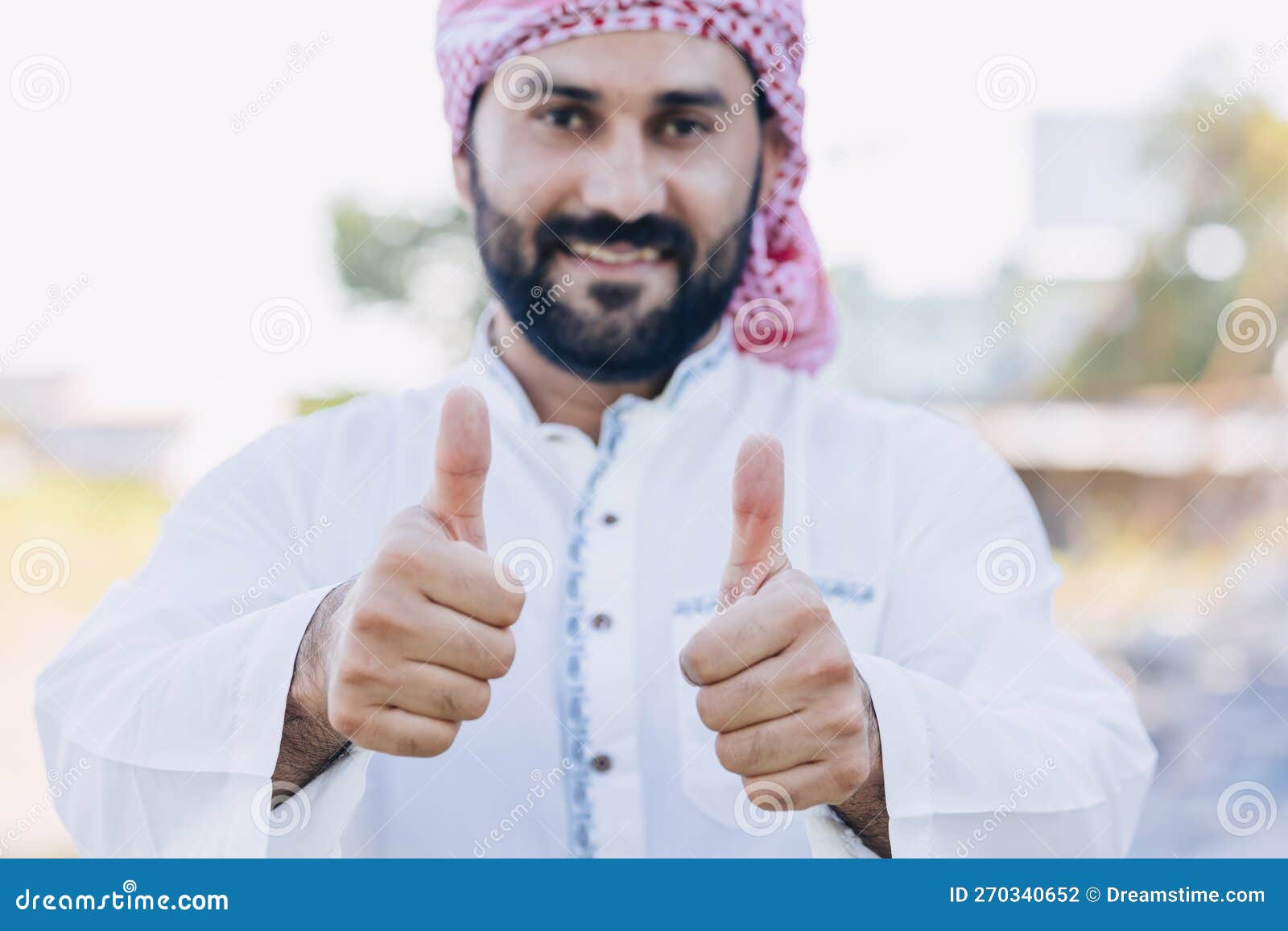 arub muslim adult male happy smiling thumbs up looking closeup