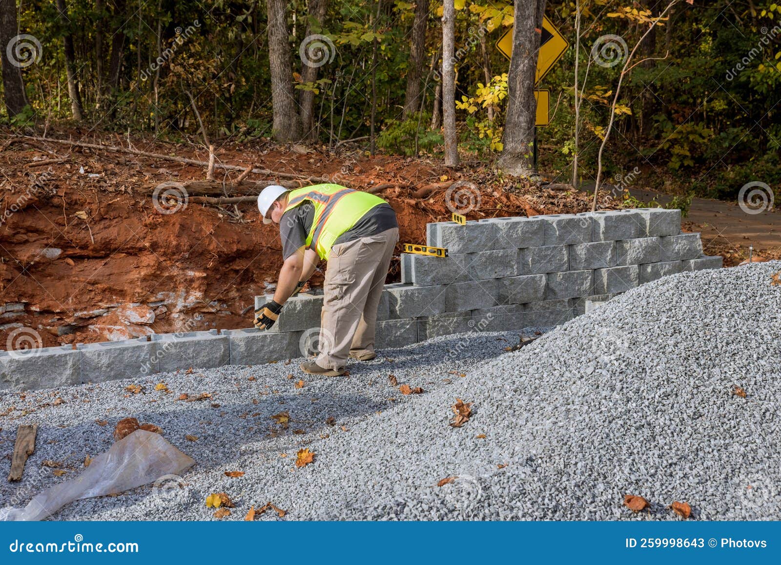 As the Contractor Worked To Construct a Large Block Retaining Wall on the Construction Site, the