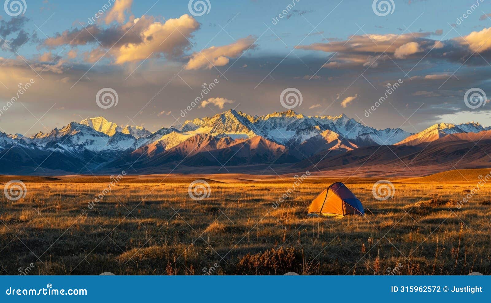 as the sun sets behind the distant mountains a solitary tent basks in the gentle light promising a night of restful