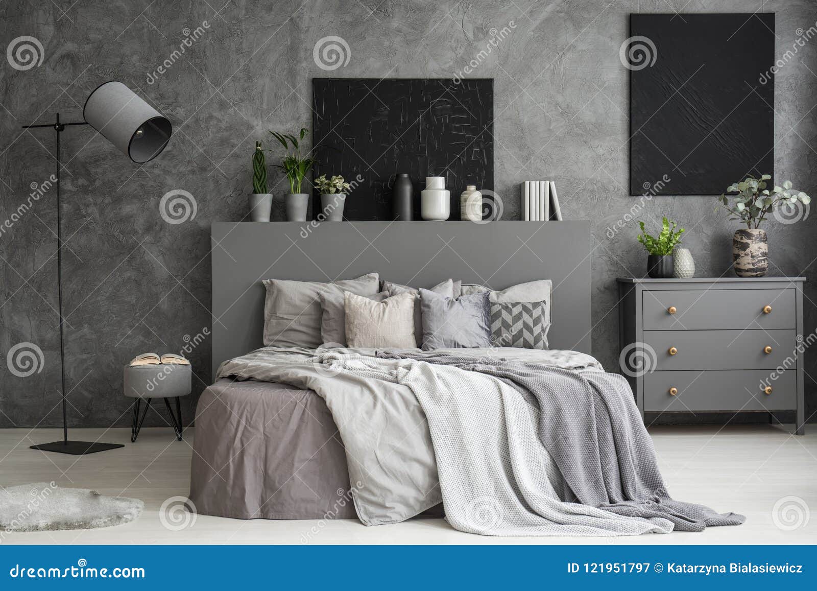 Ash Grey Bedroom Interior With Two Black Paintings On The Wall A