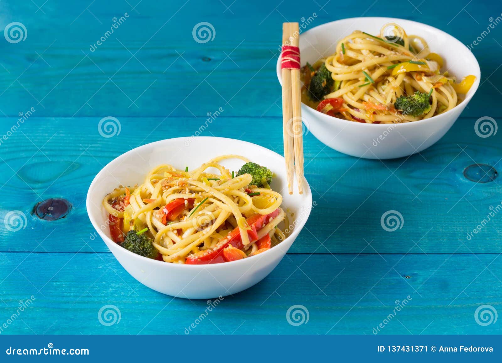 Asia Food. Stir Fry Udon Noodles with Vegetables on the Bowls on a Blue