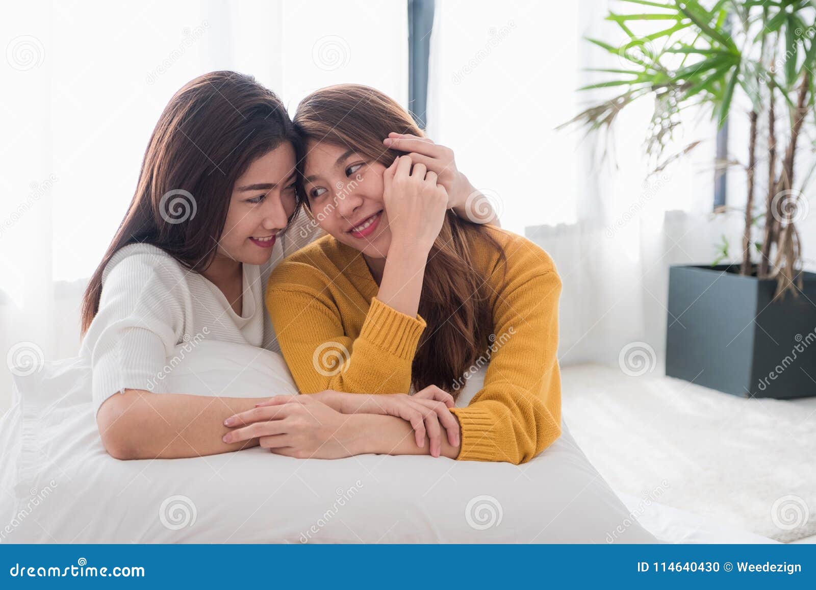 Asia Lesbian Lgbt Couple Hug And Lay On Bed Near White Window Su Stock