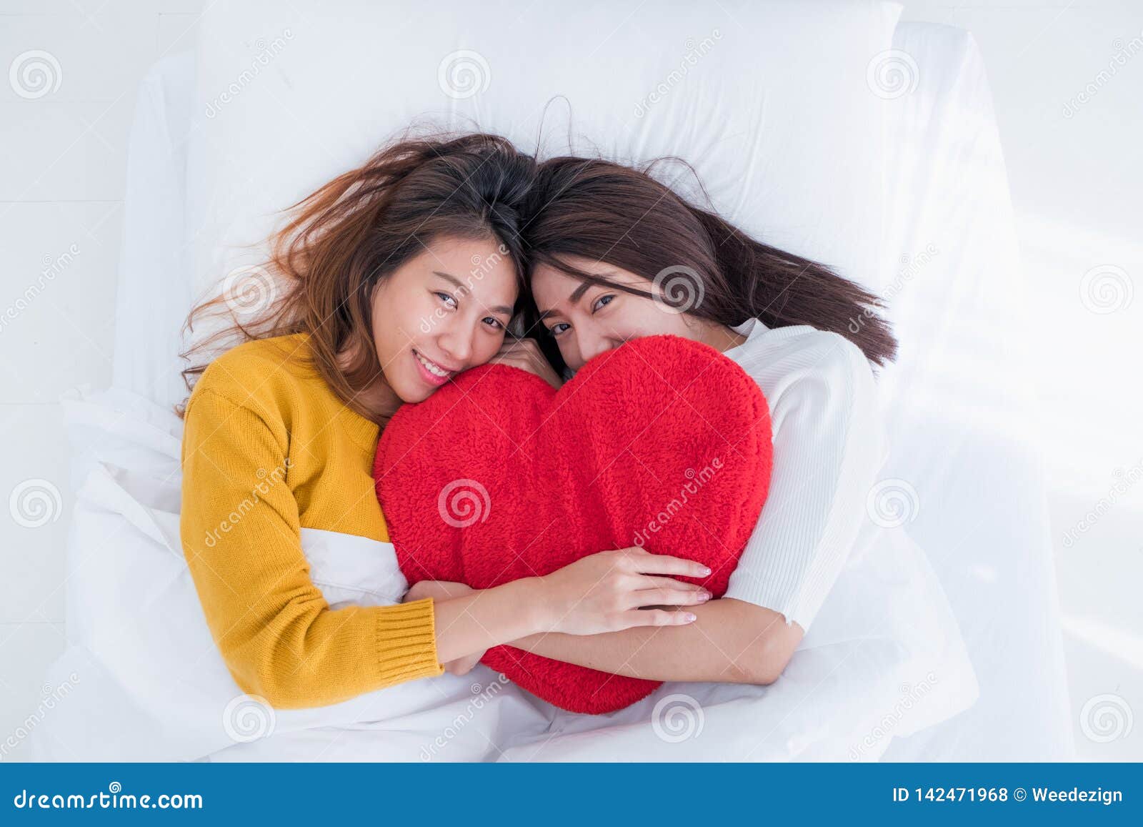 Asia Lesbian Lgbt Couple Lay On Bed And Hug Rainbow Color Pillow Heart Shape With Happiness