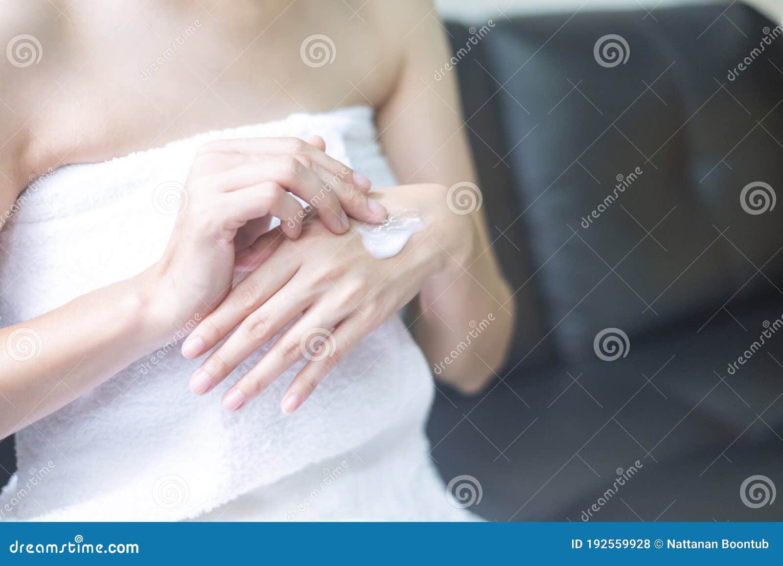 asia woman applying moisturizing cream/lotion on hands, beauty concept