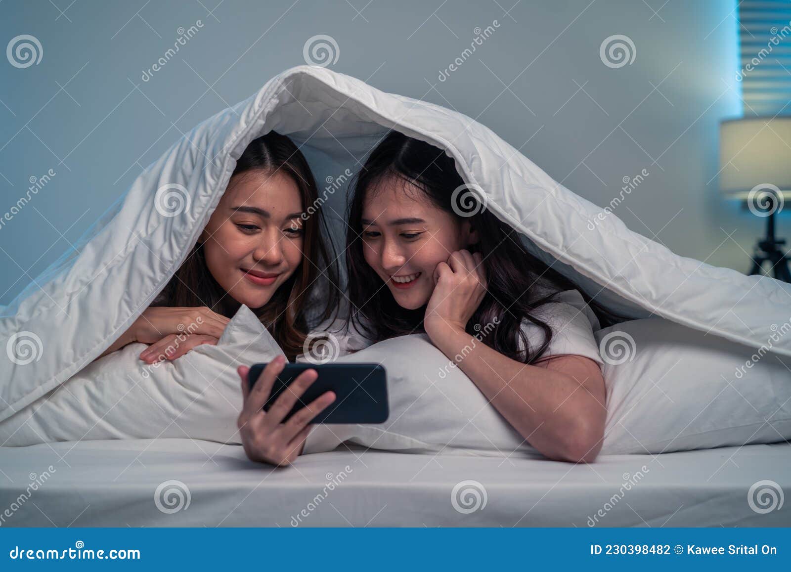 Asian Attractive Lesbian Couple Use Mobile Phone Watch Movie On Bed Beautiful Sibling In