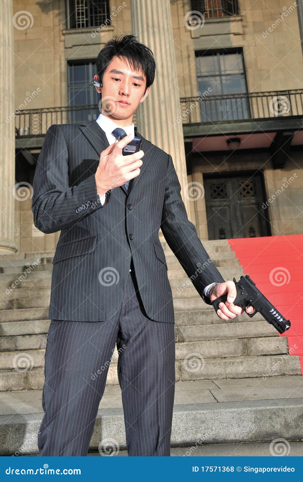 Asian Body Guard Answering His Phone For Updates 2 Stock Photo Image