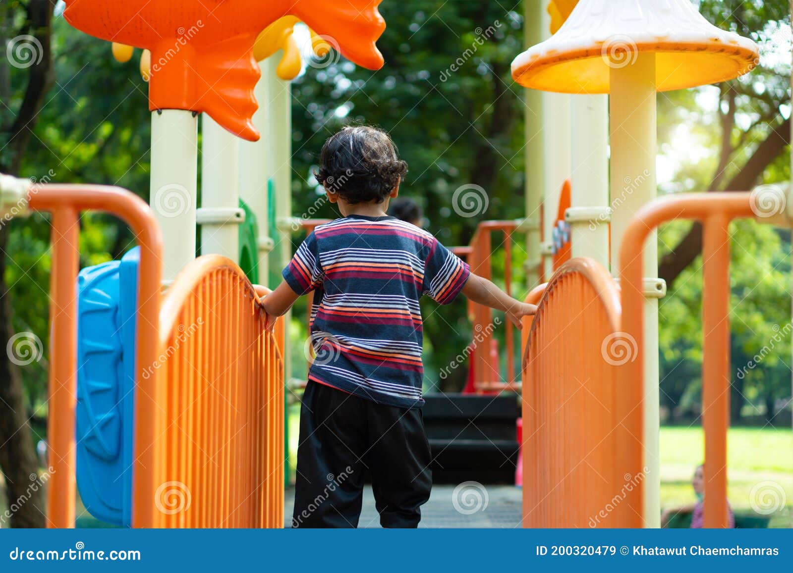 Asian Boy is Climbing on a Playground Equipment in a School Stock Image