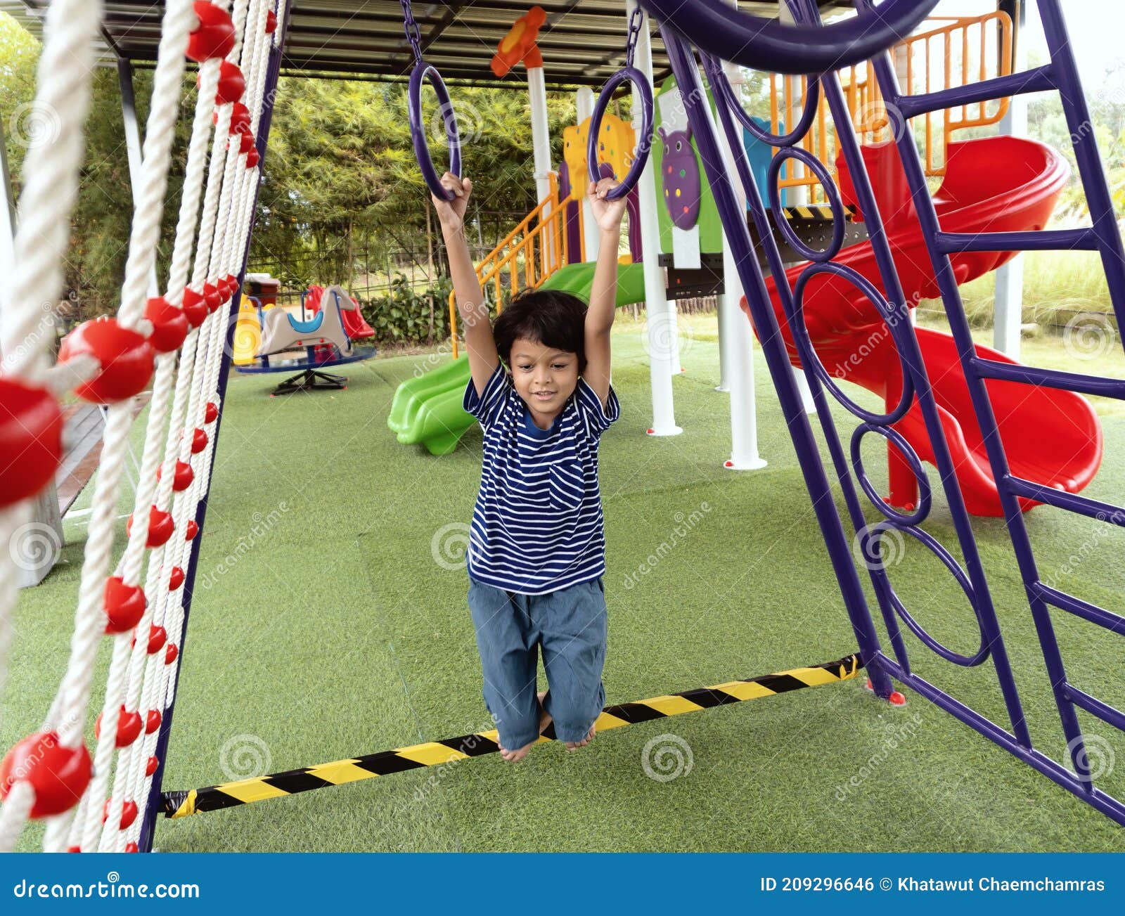 Boy is Climbing on a Playground Equipment in a School Stock Photo